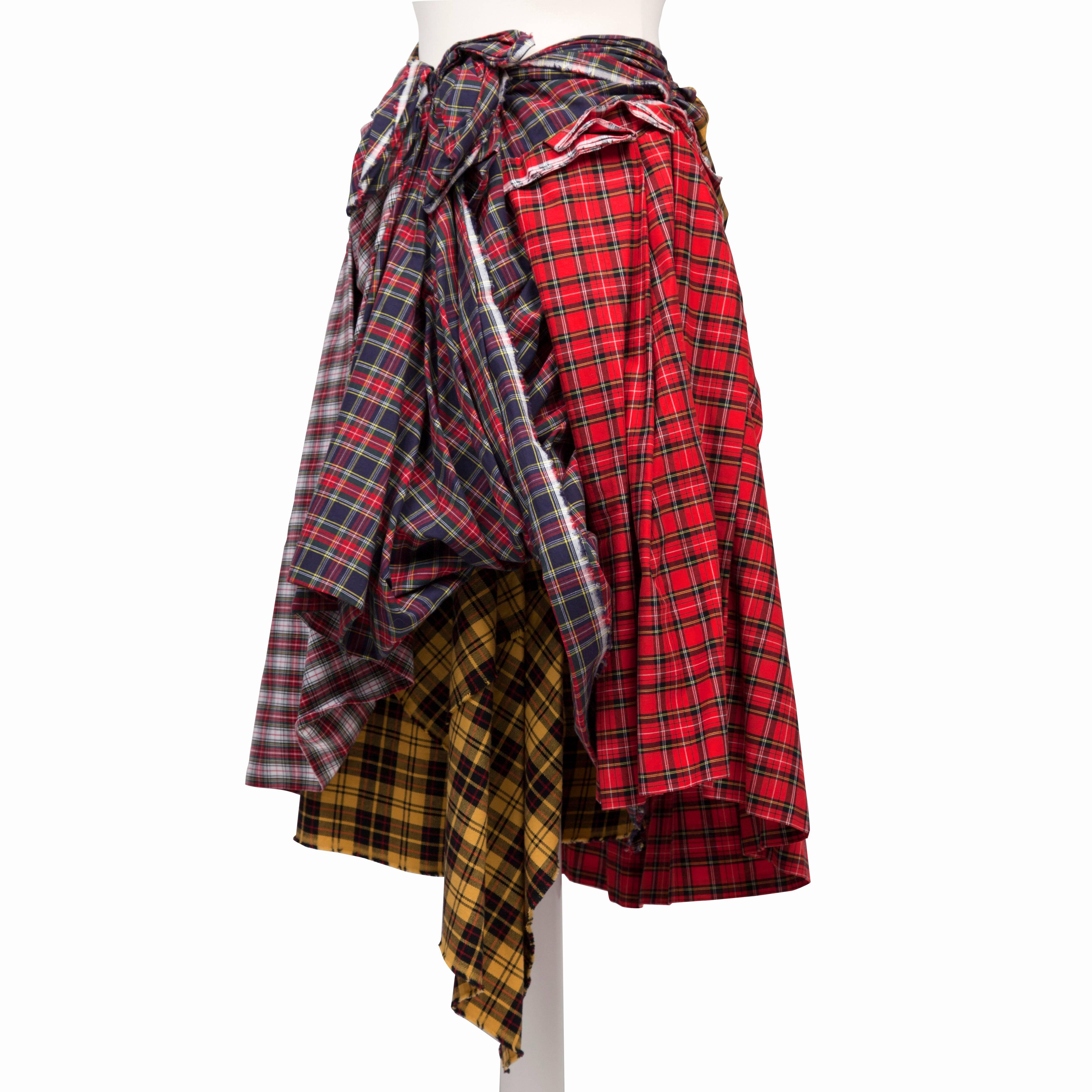 Incredible Comme des Garcons plaid skirt from AD 2005. 
Masterfully crafted piece with combination of tartan that made all sides have unique sculptural dimensions possible. Side zip opening. The exact piece was part of The Art of the In-Between :