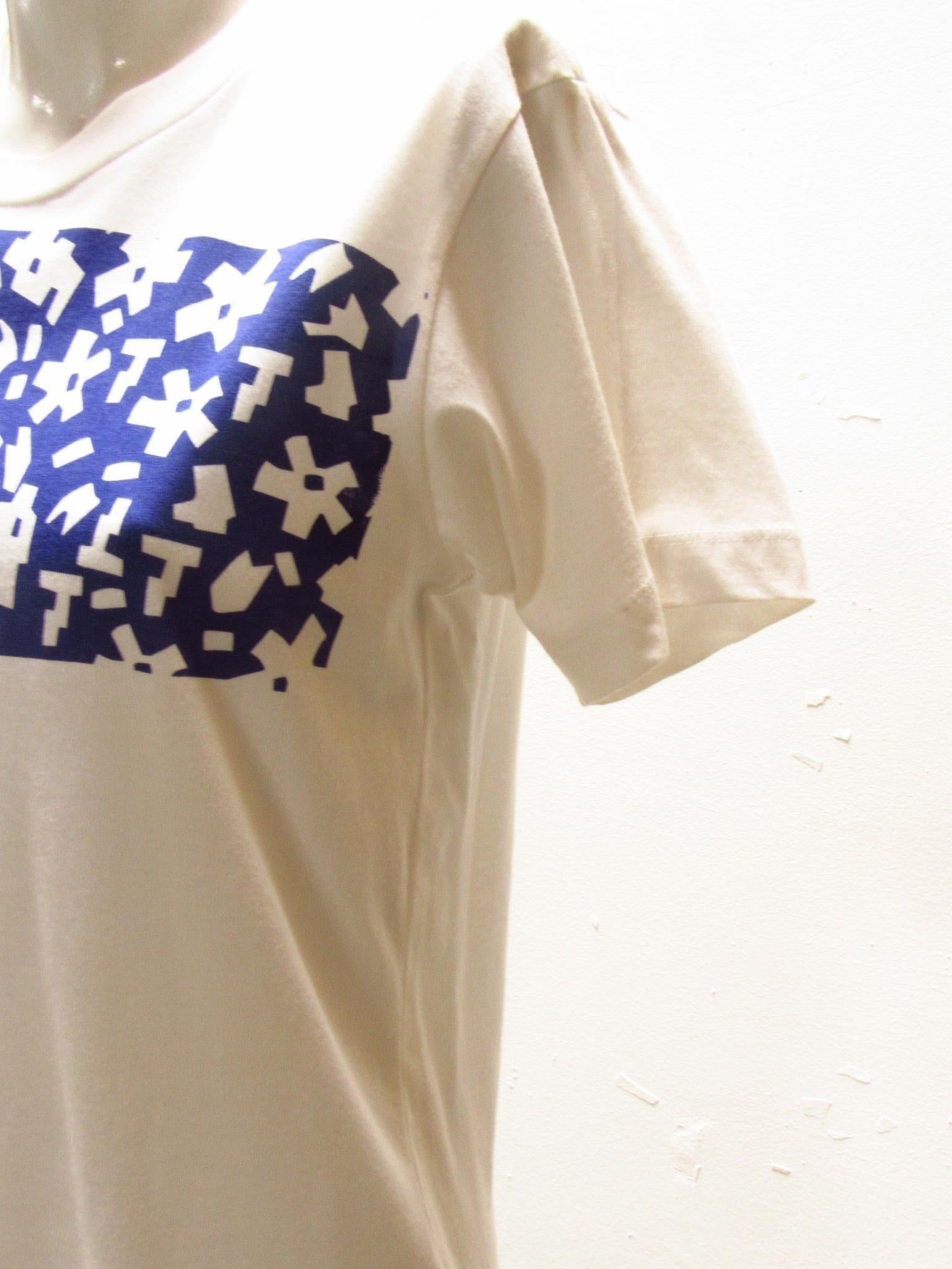 This Comme des Garçons vintage tee in 100% soft white cotton features asymmetrical royal blue print that flows across chest and onto one sleeve.