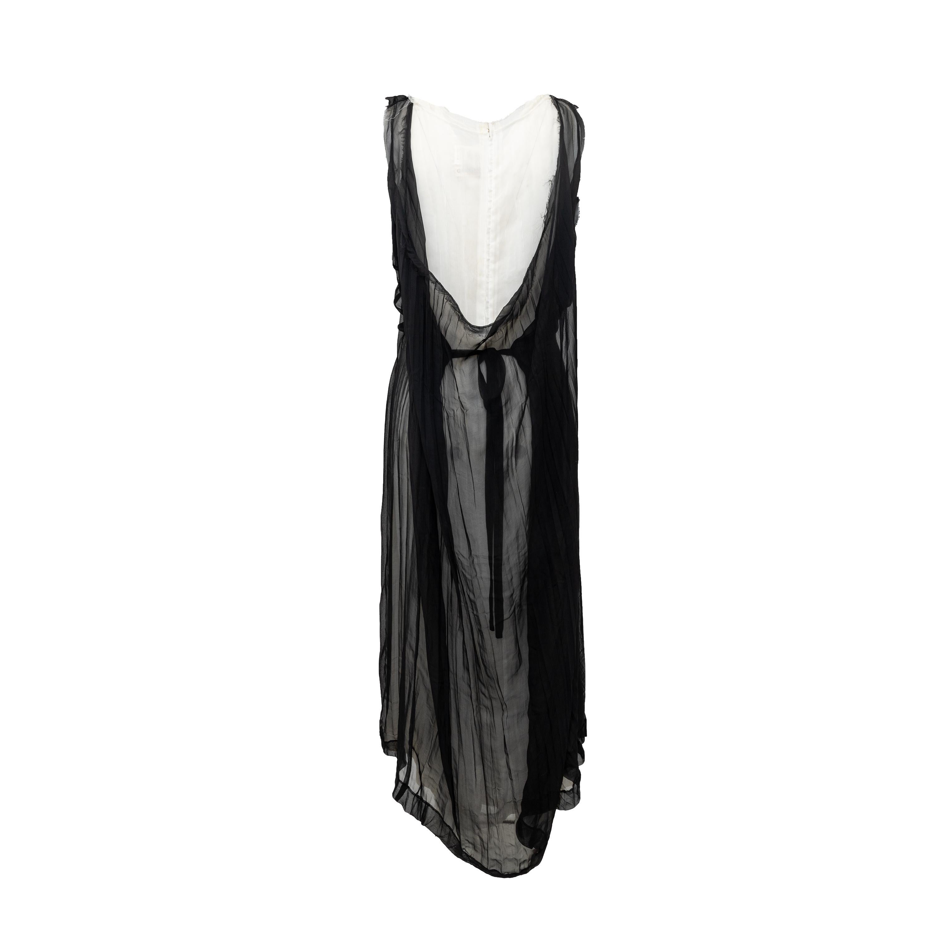 Expertly crafted by Comme des Garçons, this vintage dress features a sleeveless, black and white sheer design with a raw edge for a unique touch. The Grecian-style dress also includes a zip fastening on the lower layer and a tie-knot at the waist,