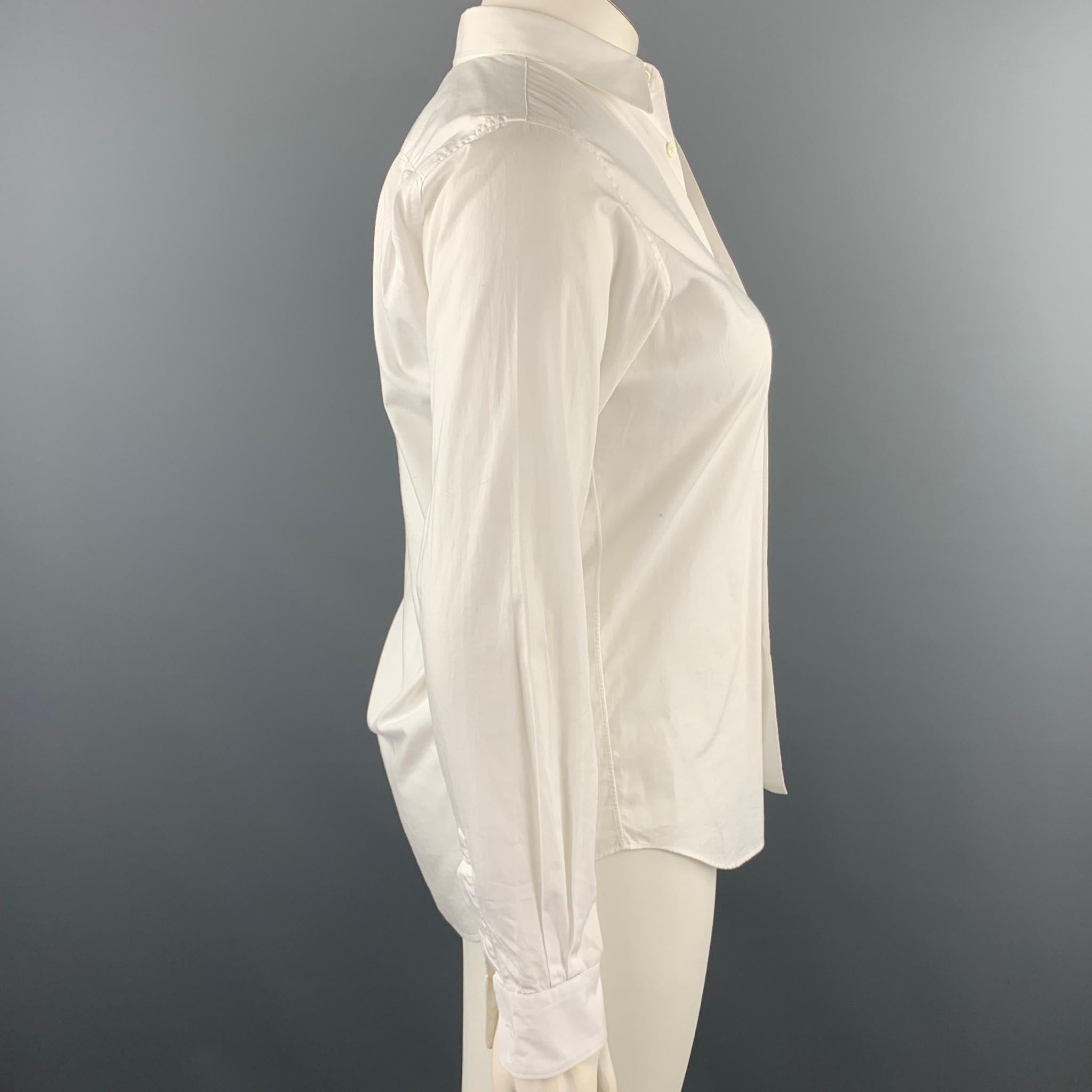 COMME des GARCONS SHIRT blouse comes in a white cotton with a contrast front pocket featuring a button up style and a spread collar. Made in France.

Very Good Pre-Owned Condition.
Marked: X

Measurements:

Shoulder: 15.5 in. 
Bust: 38 in. 
Sleeve: