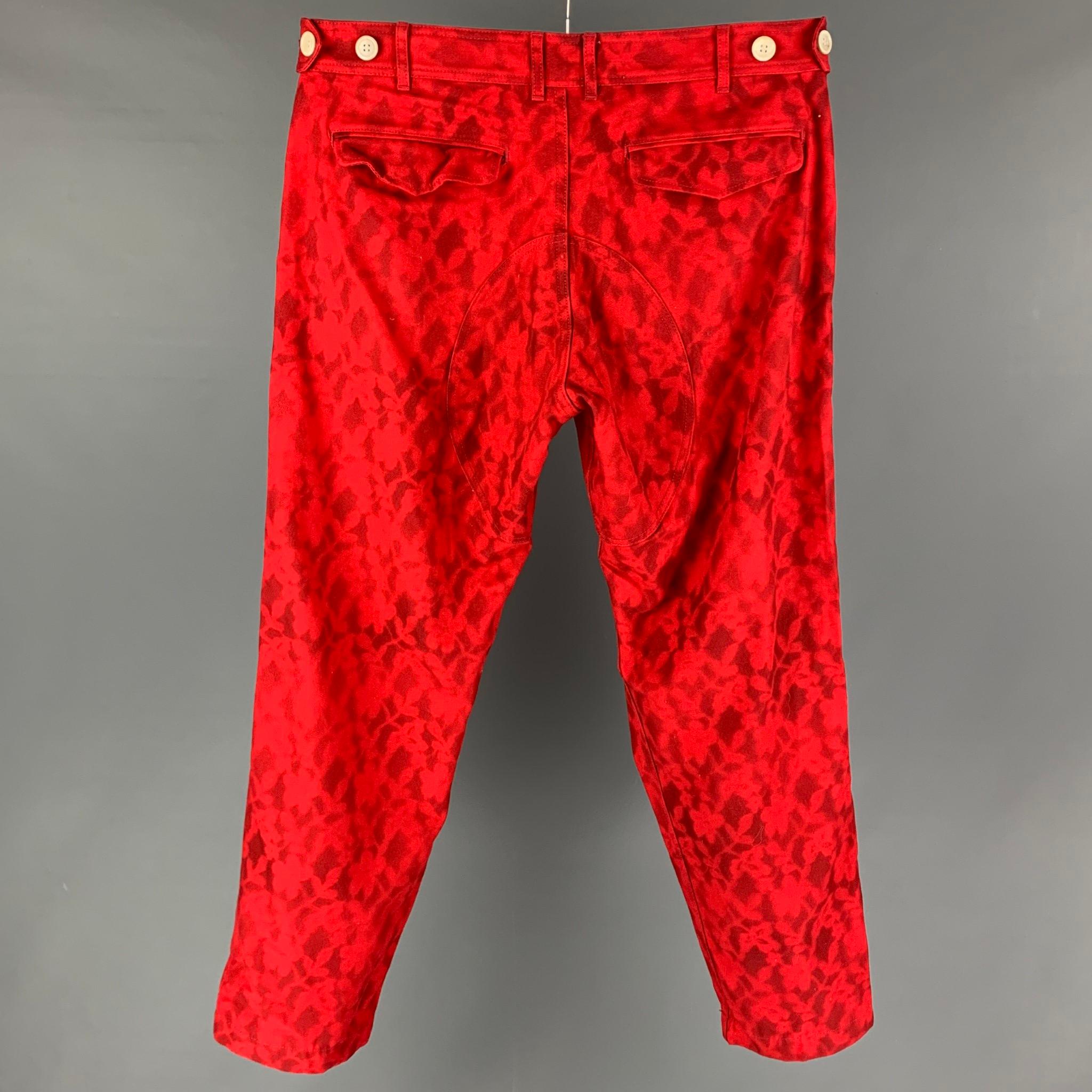 COMME des GARCONS SHIRT casual pants comes in a red & black dyed cotton featuring side tabs, loose fit, and a zip fly closure. Made in Japan. 

Very Good Pre-Owned Condition.
Marked: X

Measurements:

Waist: 36 in.
Rise: 12 in.
Inseam: 32 in. 