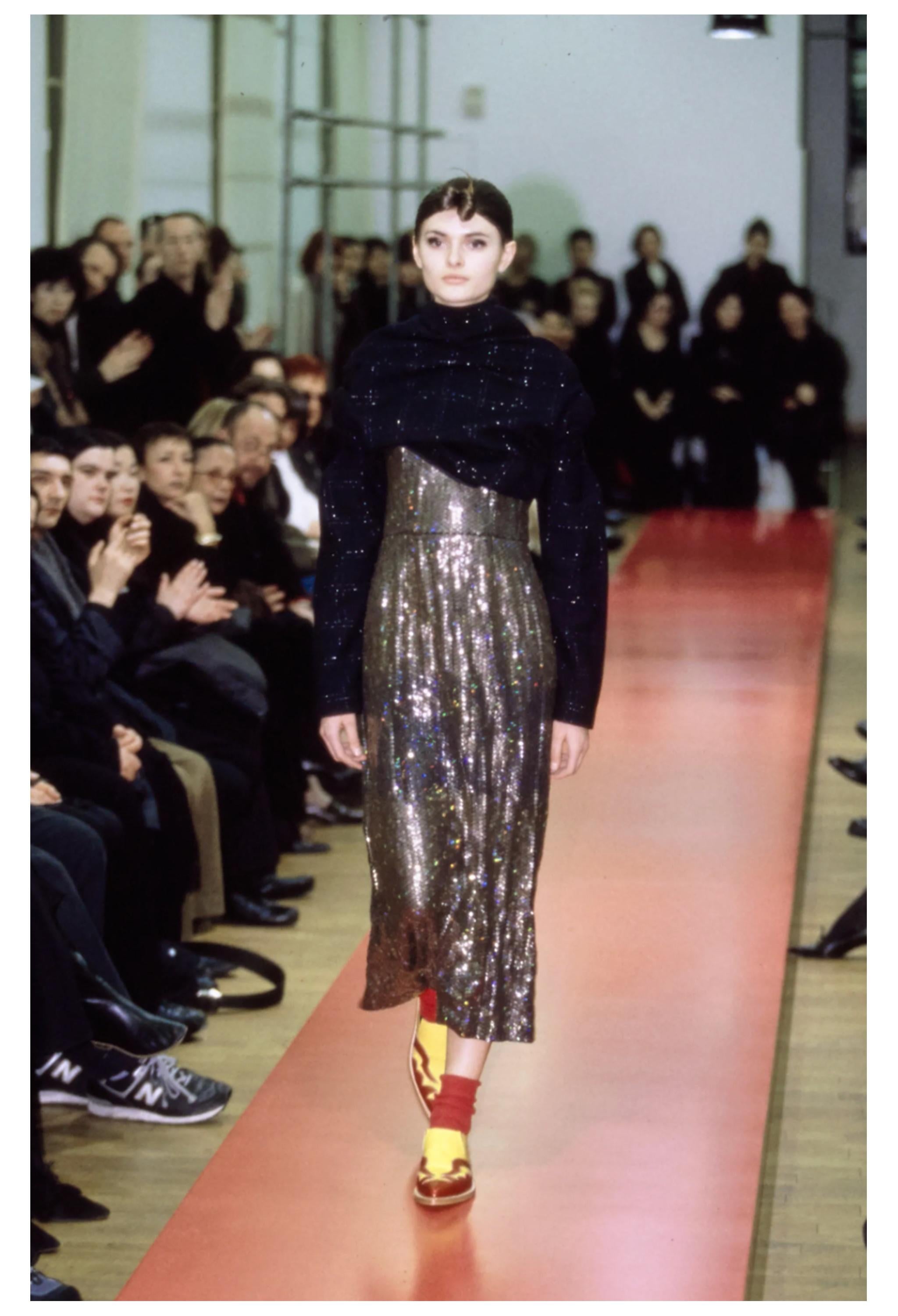 Resurrection Vintage is excited to offer a vintage Comme des Garçons silver sequin cocktail dress with rainbow reflections, featuring an asymmetrical neckline and hem, a sleeveless body, and a below-the-knee length.  

Comme Des Garçons
Size