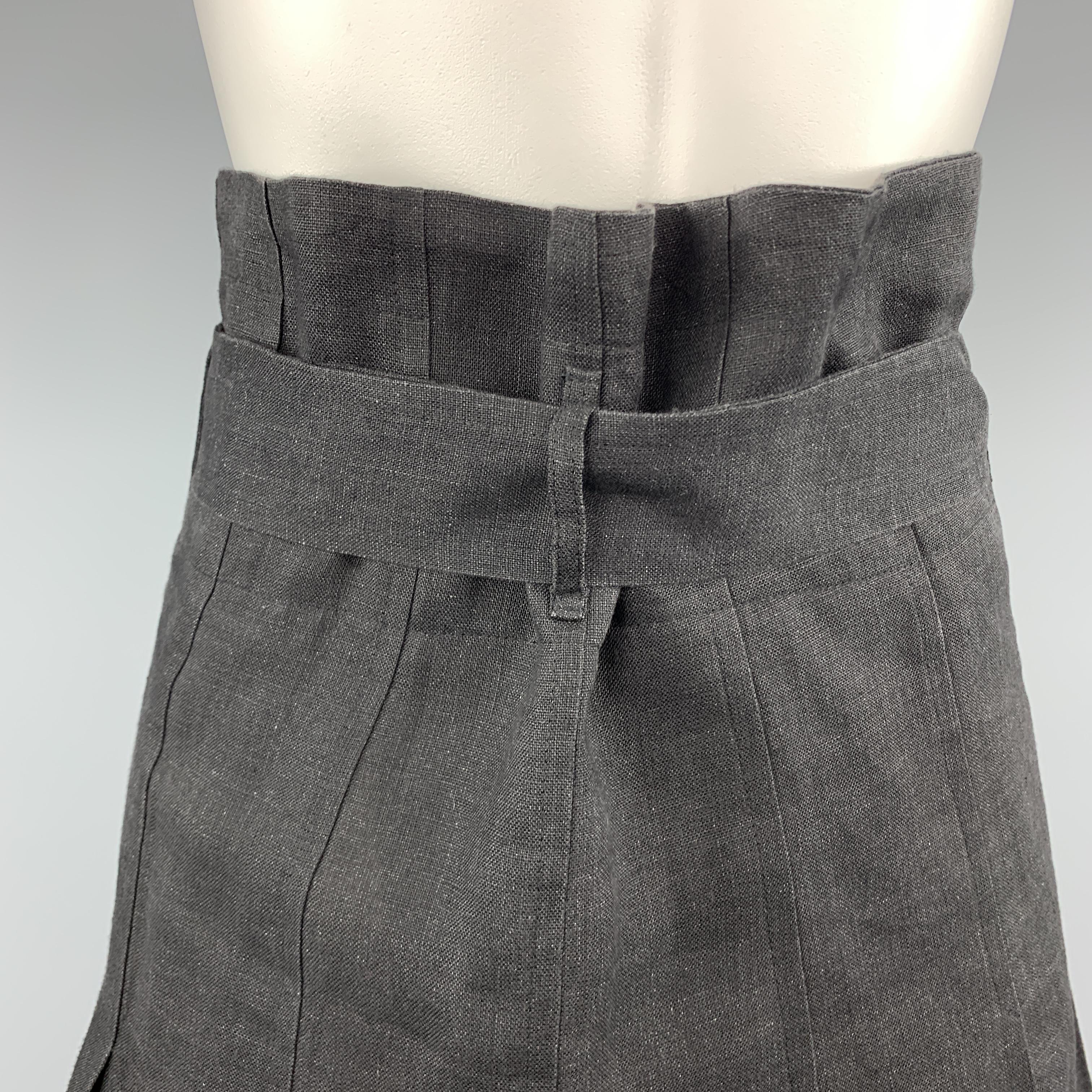 Vintage COMME des GARCONS skirt comes in black linen with box pleats and a partially internal waistband that gathers the top. Made in France.
 
Excellent Pre-Owned Condition.
Marked: S
 
Measurements:
 
Waist: 30 in.
Hip: 37 in.
Length: 22 in.