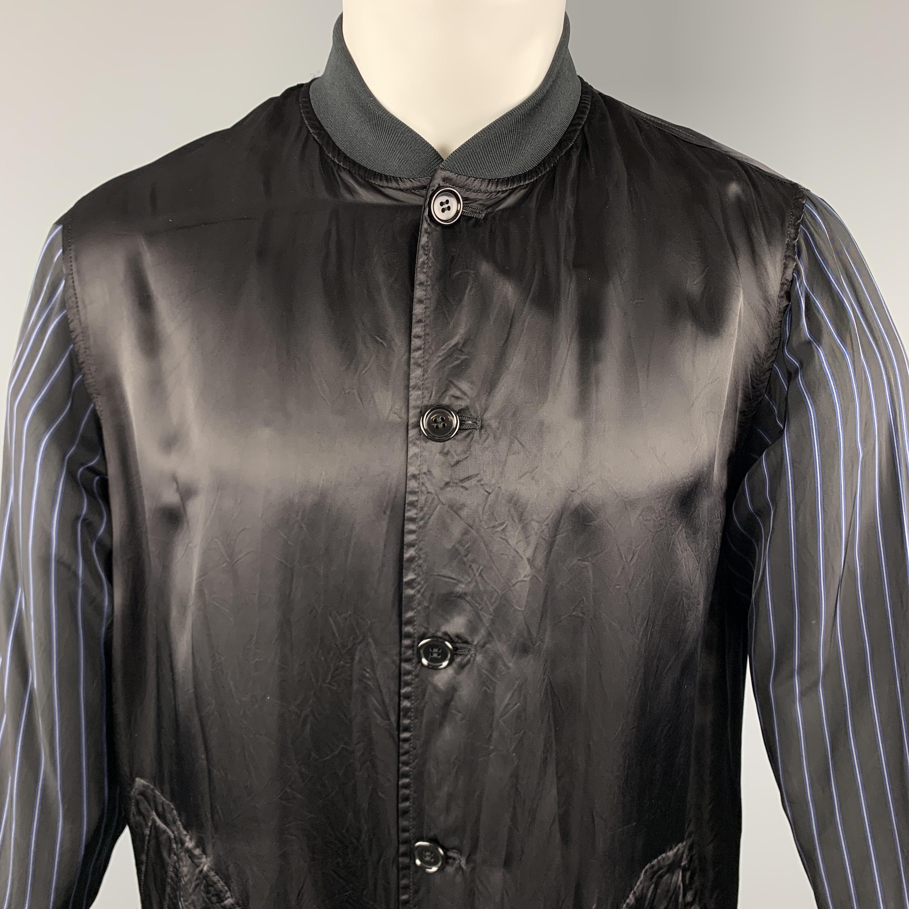 COMME des GARCONS GOOD DESIGN SHOP Re-Edition 1986 Staff Coat comes in a black solid and striped mixed fabrics, with a buttoned front, six buttons at closure, patch pockets, striped sleeves, a 