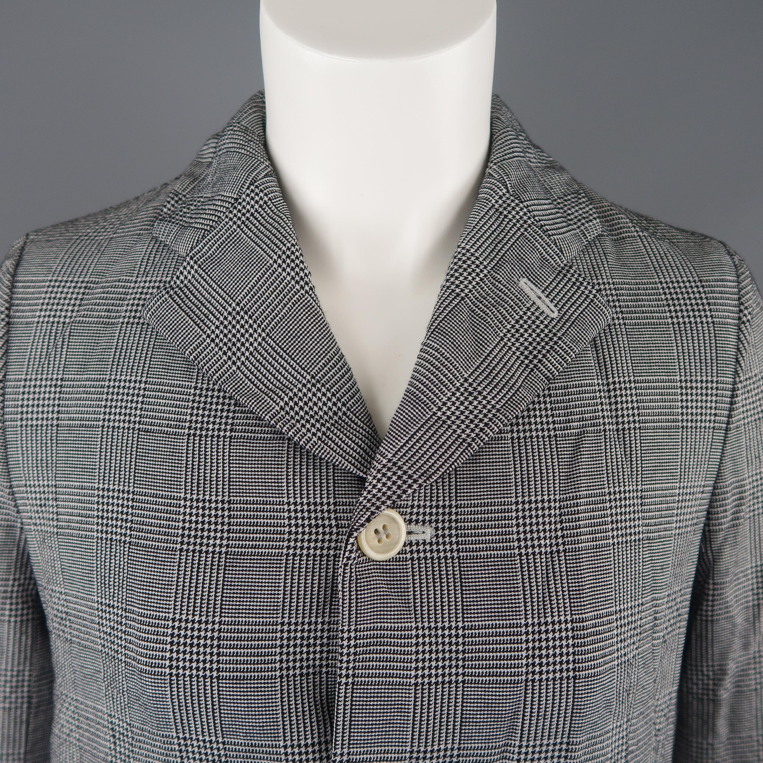 COMME des GARCONS blazer jacket comes in wrinkle textured black and white glenplaid print wool blend fabric with a notch lapel, three button half closure, flap pockets, and A line silhouette. Made in Japan.
 
Excellent Pre-Owned Condition.
Marked: