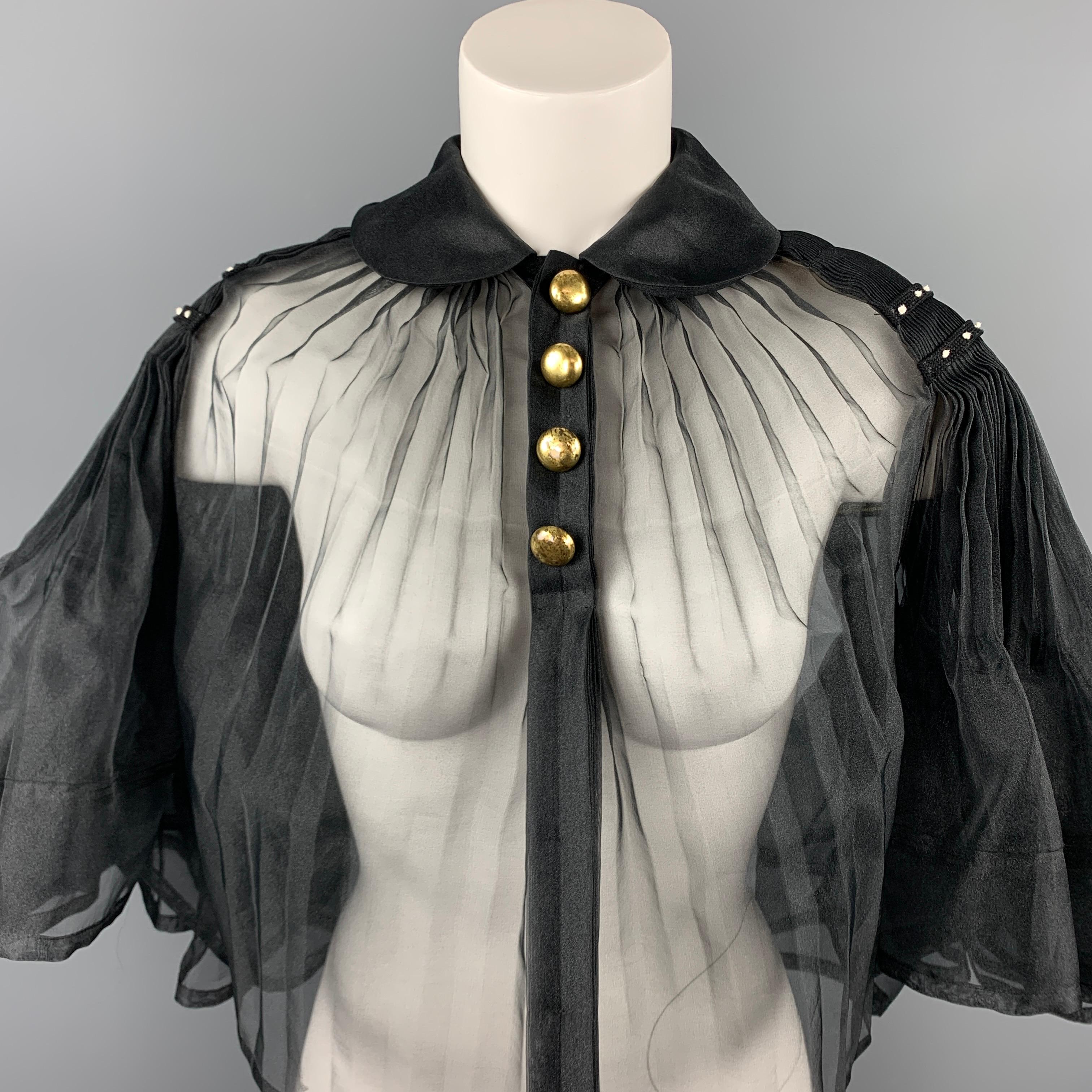 COMME des GARCONS TAO cape comes in a black pleated polyester featuring a spread collar, open back, button details, and a snap button closure.

Good Pre-Owed Condition.
Marked : M / AD 2008
