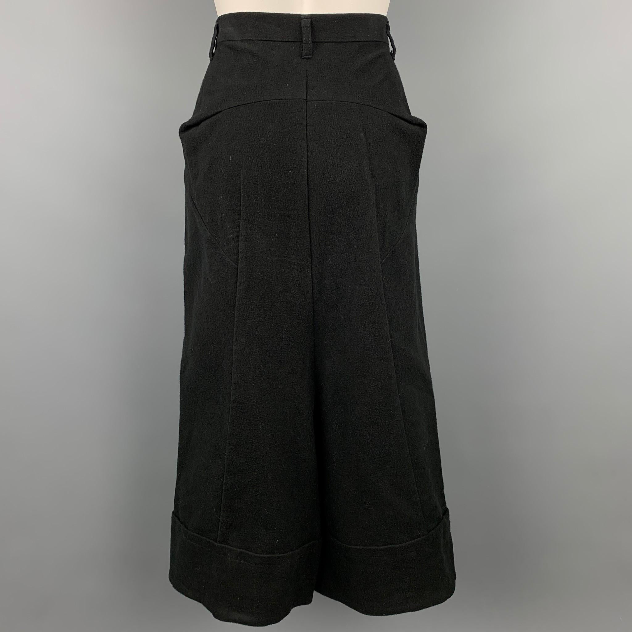 COMME des GARCONS TRICOT casual pants comes in a black cotton featuring a drop crotch style, wide leg, and a zip fly closure. Made in Japan.

Very Good  Pre-Owned Condition.
Marked: M / AD2014

Measurements:

Waist:  28 in.
Rise: 25. in.
Inseam: 11