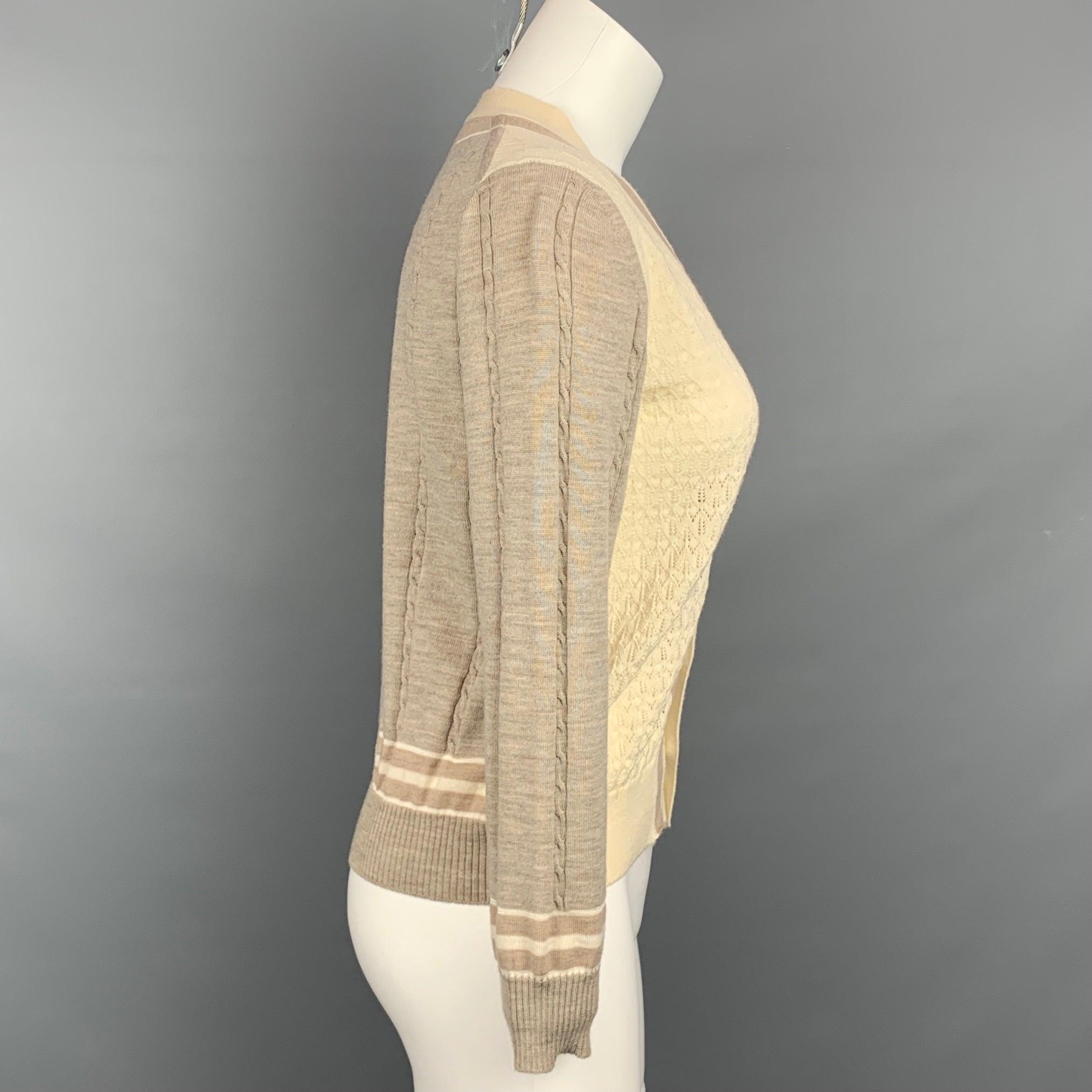COMME des GARCONS TRICOT cardigan comes in a taupe & cream textured knit material featuring a ribbed hem, striped trim, and a buttoned closure.Very Good
 Pre-Owned Condition. 
 

 Marked:  Size tag removed.  
 

 Measurements: 
  
 Shoulder: 16