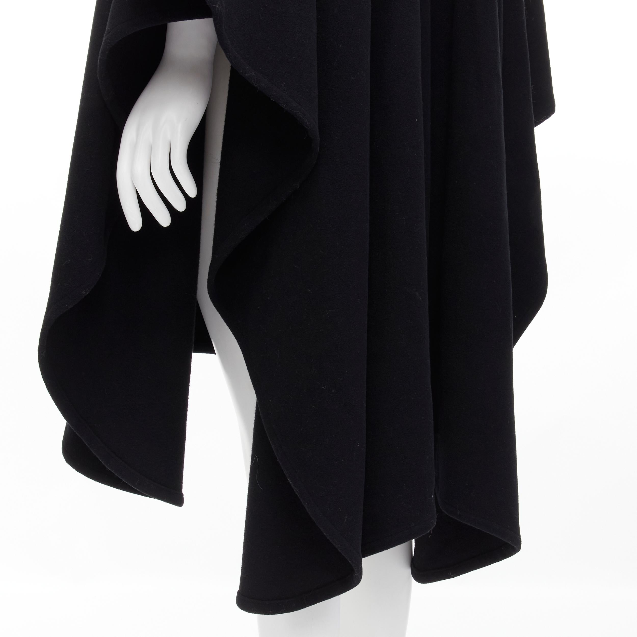COMME DES GARCONS Vintage 1980s black wool wide ruffle collar circle poncho cape 
Reference: CRTI/A00549 
Brand: Comme Des Garcons 
Designer: Rei Kawakubo 
Collection: 1980's 
Material: Wool 
Color: Black 
Pattern: Solid 
Extra Detail: Circle cut
