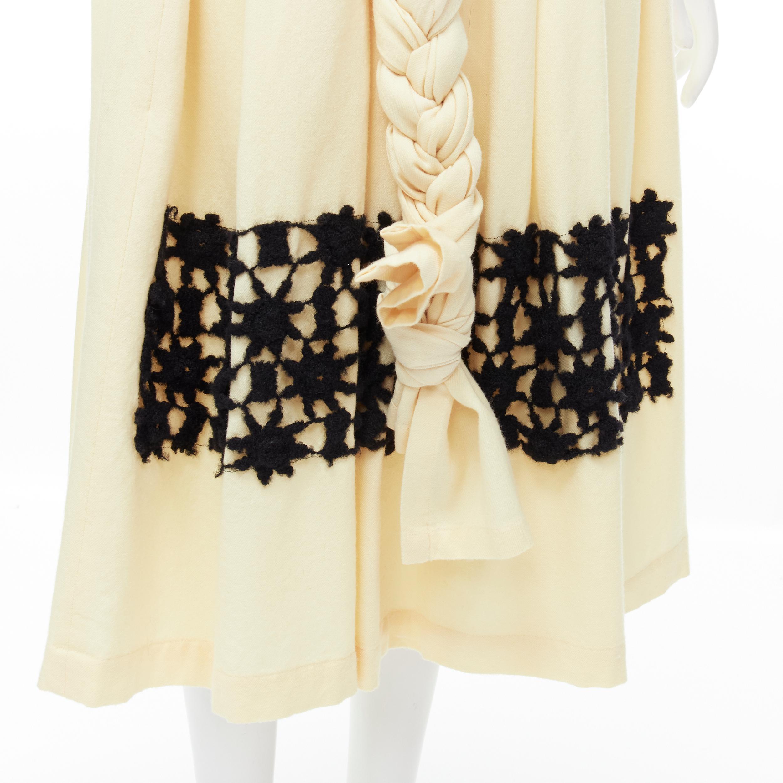 COMME DES GARCONS Vintage 1988 cream wool braid black lattice embroidery skirt M 
Reference: CRTI/A00560 
Brand: Comme Des Garcons 
Designer: Rei Kawakubo 
Collection: 1988 
Material: Wool 
Color: Cream 
Pattern: Solid 
Closure: Embroidery 
Extra