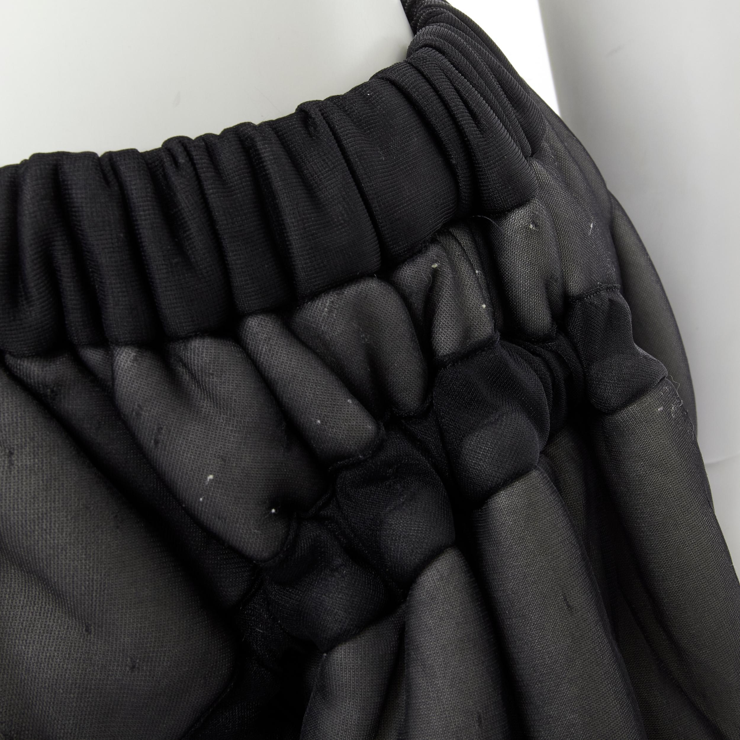 COMME DES GARCONS Vintage 1990 black sheer nylon drawstring padded puffy skirt M 
Reference: CRTI/A00561 
Brand: Comme Des Garcons 
Designer: Rei Kawakubo 
Collection: 1990 
Material: Nylon 
Color: Black 
Pattern: Solid 
Closure: Drawstring 
Extra
