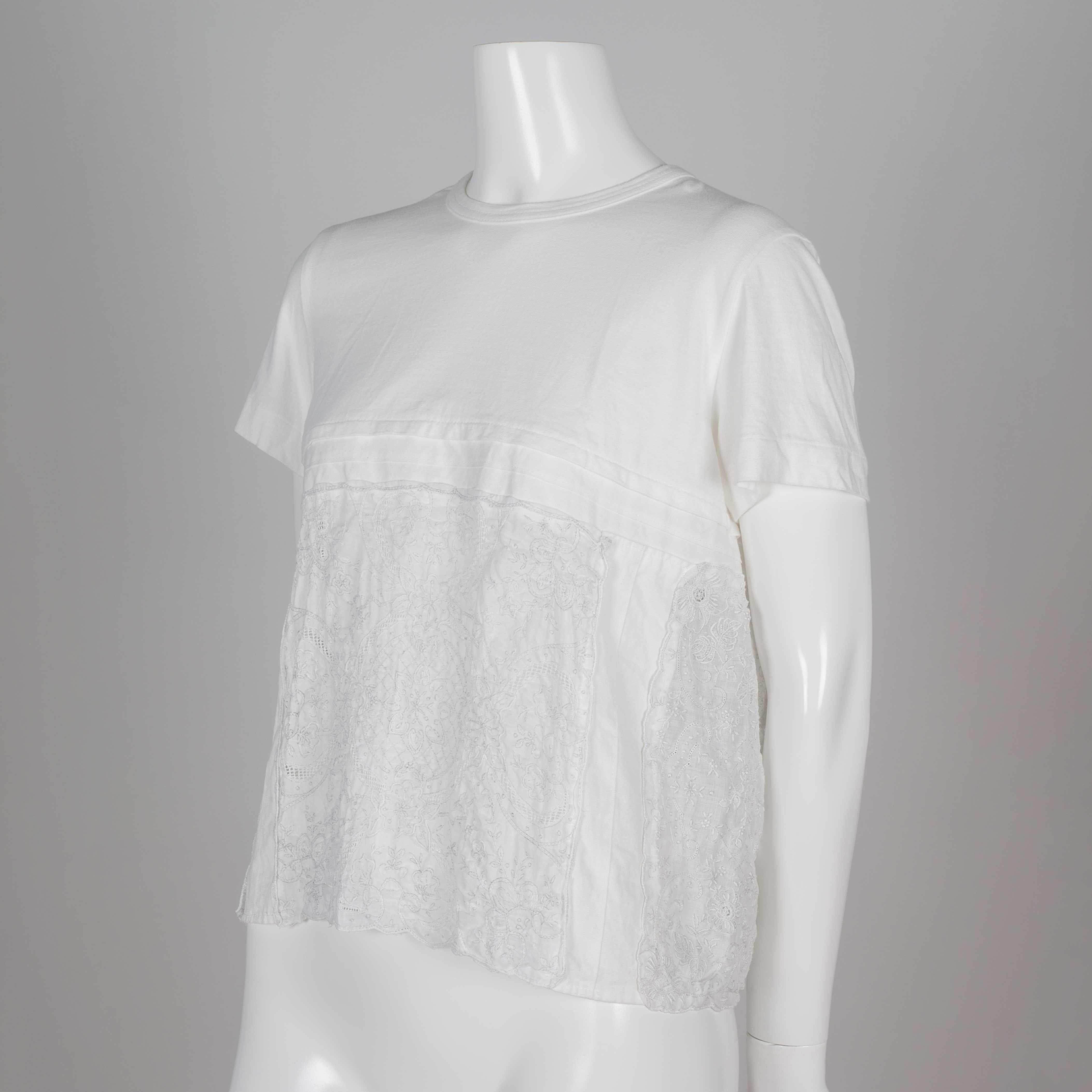 Comme des Garçons Tao light, breezy white t-shirt from Japan with cotton upper and embroidered linen lower that gives an effect of lace. Buttons line the cotton back of the top, and the linen lower back is open. Perfect casual, soft tee with lacy