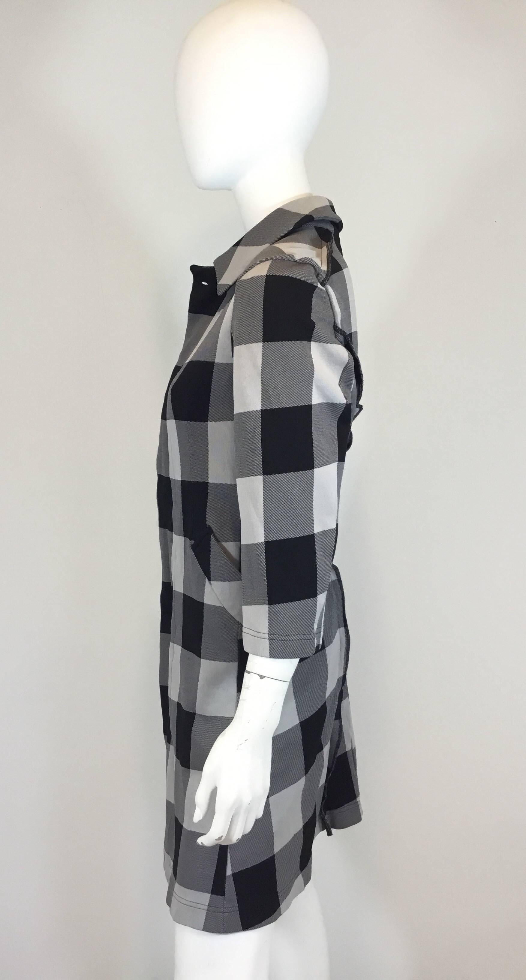 Comme des Garçons grey and black plaid Checkered patterned jacket with concealed button closures at the front and two pockets at the hips. Draped garment with unique style lines. Jacket made with 100% polyester and made in Japan. Excellent