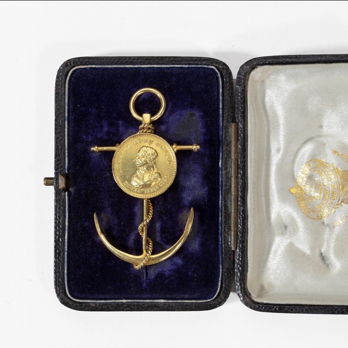 Commemorative brooch by Edmund Johnson Ltd of Dublin, in 18-carat gold with its original fitted case

Designed in the form of an anchor, set with a commemorative medallion with portrait of “Admiral Lord Nelson, born 9th September 1758”, the anchor