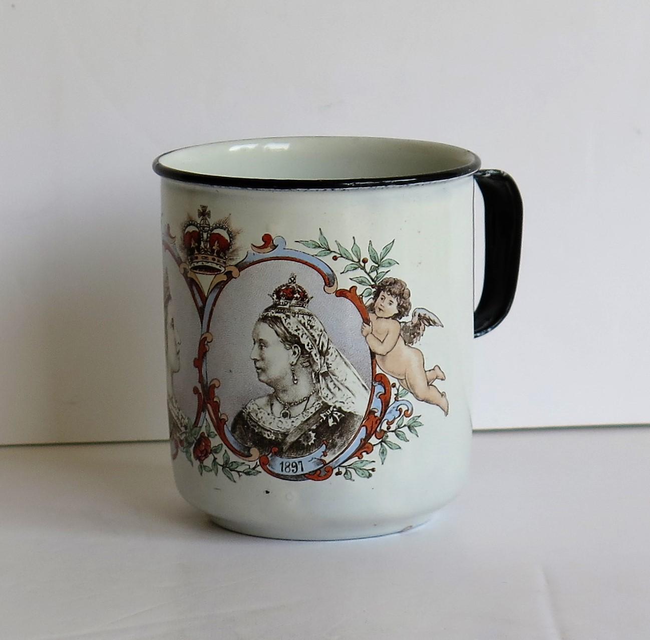 This is a good late 19th century enamelled tin mug or cup made in 1897 to commemorate the Diamond Jubilee of Queen Victoria.

The piece is made in the shape of a coffee can or mug with a loop handle.

It has been decorated with a coloured