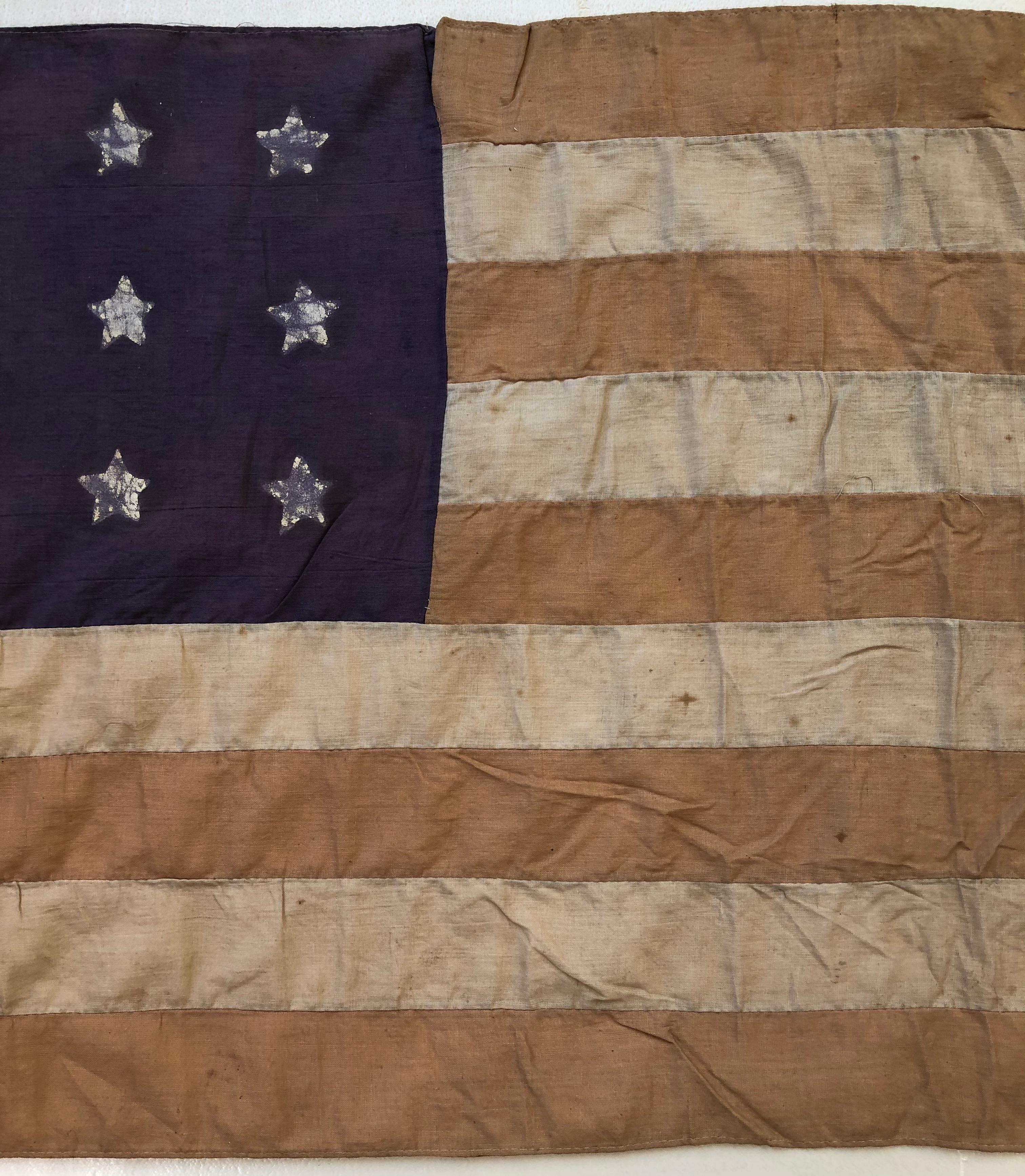 WWII French Liberation Day American flag handmade by French citizens that were used during parades in appreciation of the American military involvement. This historical flag is presented on its original pole with the inscriptions RF 