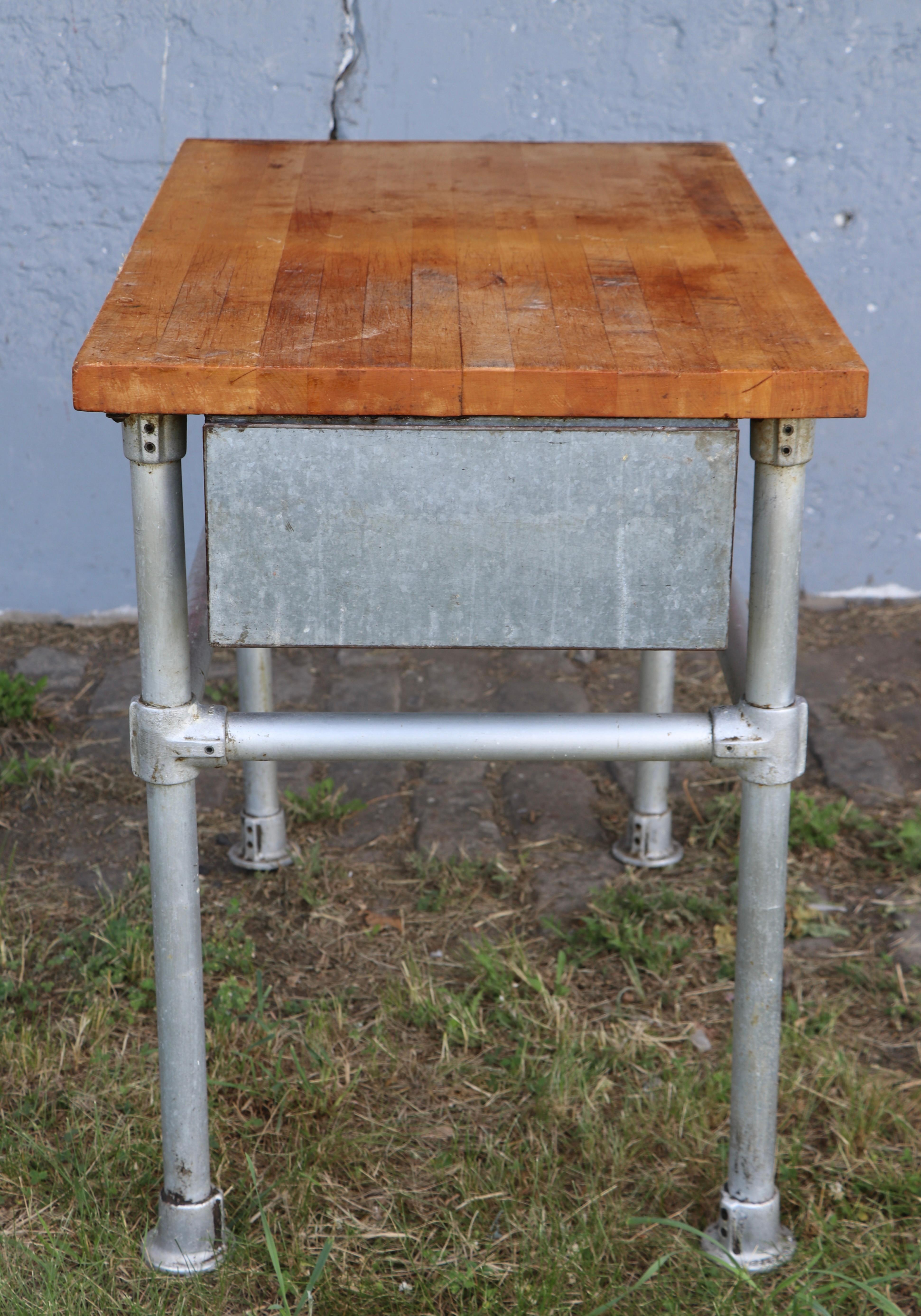 Nice butcher block top, iron pipe base commercial grade work table with a deep storage drawer. The table is in good original condition, sturdy stable and ready for regular and heavy use, shows expected signs of age and use. This example was