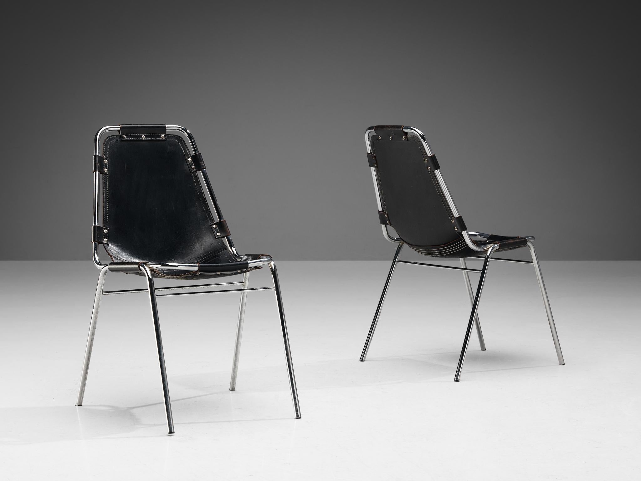 Dal Vera pair of 'Les Arcs' chairs, selected by Charlotte Perriand, pair of dining chairs model 'Les Arcs', black leather, chrome-plated metal, circa. 1970 

This well-constructed pair of chairs were manufactured by Dal Vera and selected by
