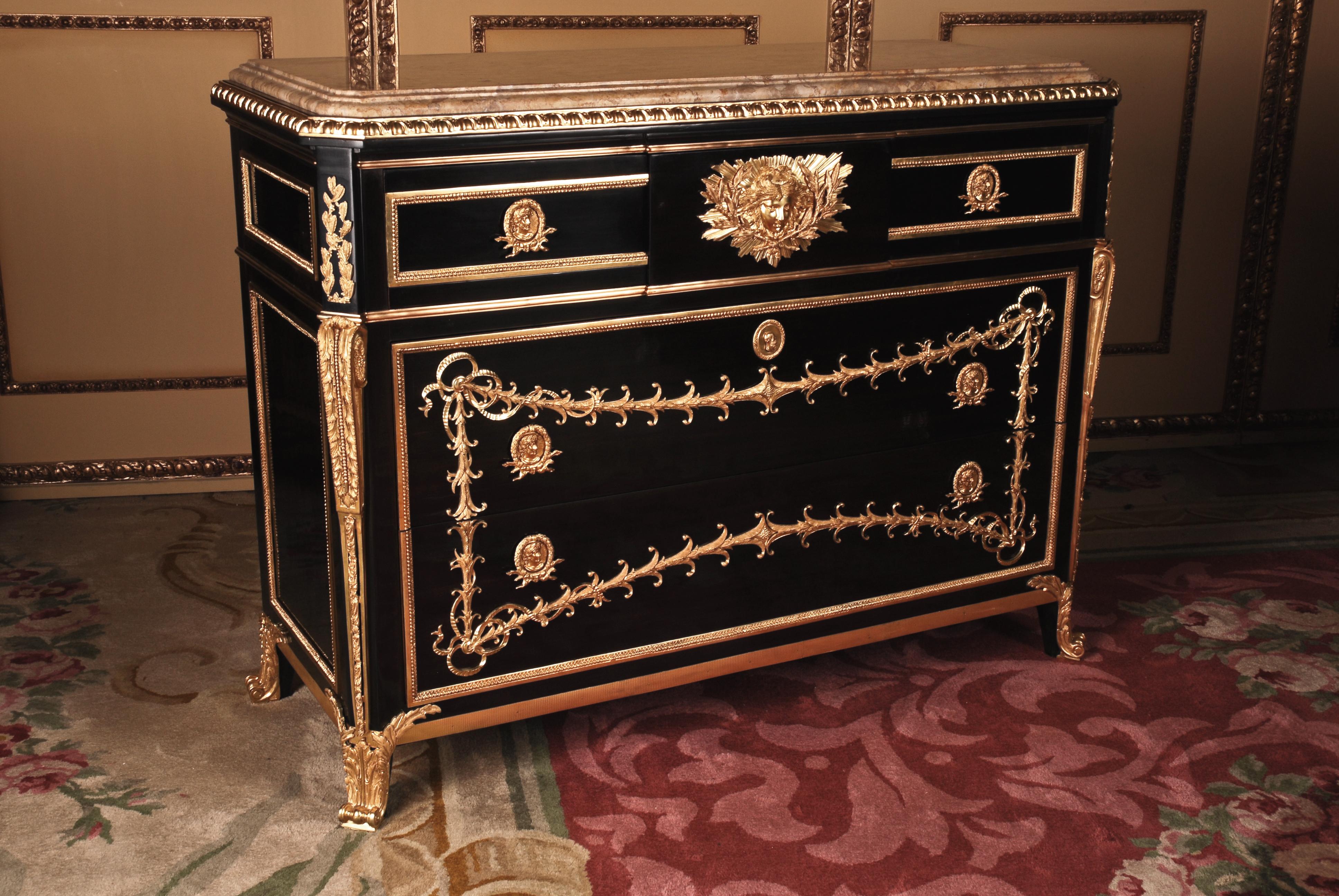 Commode after the Original Model from Jean Henri Riesener 
in Transition Style
Lightly modified model after an original by Jean Henri Riesener
(1734 – 1806). Ebonized solid Beech. Rectangular corpus on Bronze caps ending feet. The middle drawer