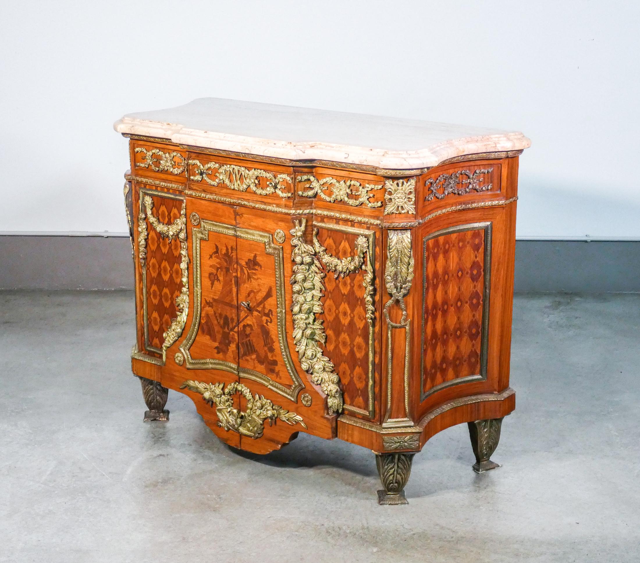Commode in
Louis XV / Transition
style on the original model made
by Jean H. RIESNER.
Inlaid wood and bronze

Period
Early twentieth century

Model
Sideboard based on the original model by Jean Henri RIESNER

Materials
Inlaid wood