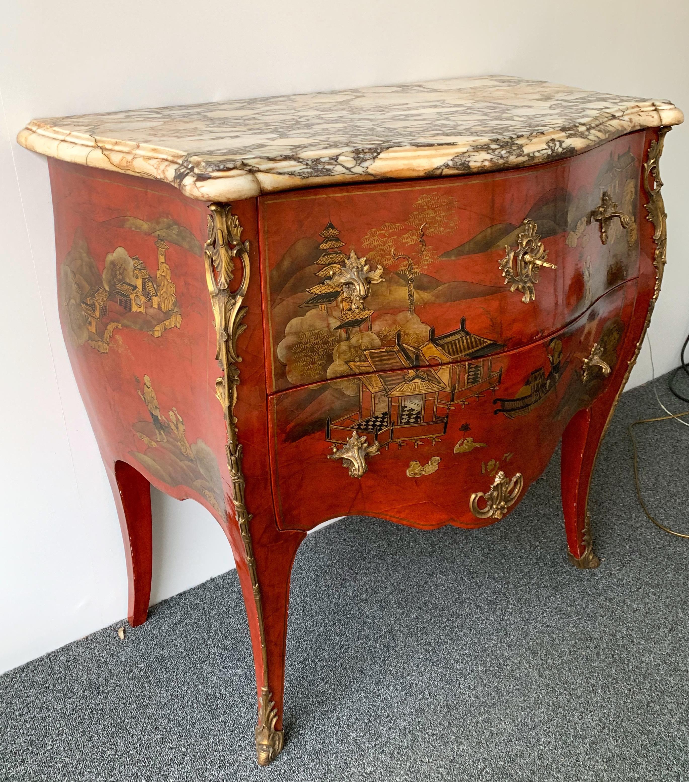 Commode, chest of drawers or dresser highly-decorative and very good quality by Maison Jansen, in the Louis XV Regence Rococo style with red lacquered chinoiserie designs, well-cast gilt bronze mounts, two drawers with working lock and key, and