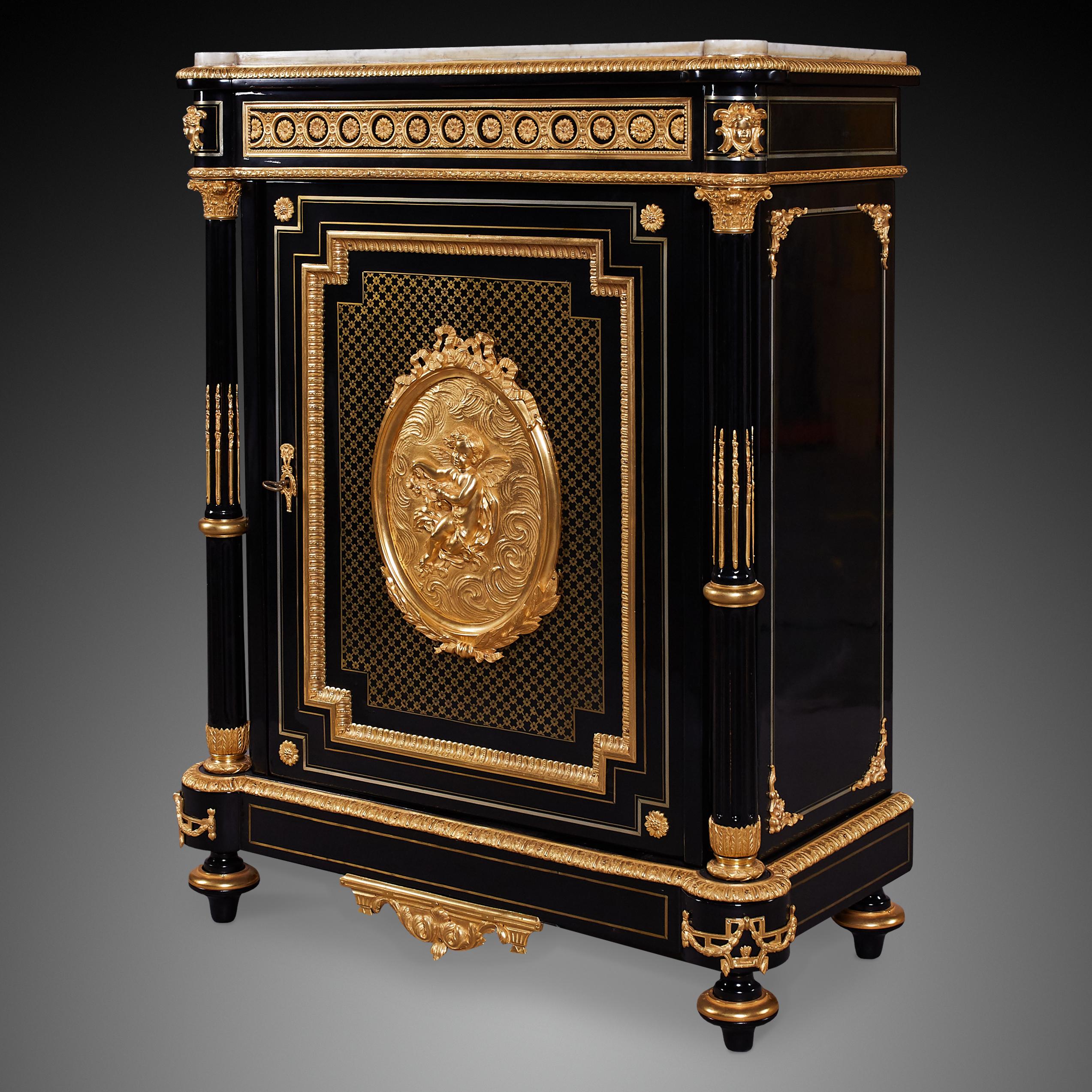 Black ebonised 19th c., Napoleon III style ormolu cabinet. Like many cabinets from this period the cabinet is heavily embellished with ormolu mouldings and decorative patterns with ancient Greco-Roman inspired motifs. The empire style was introduced