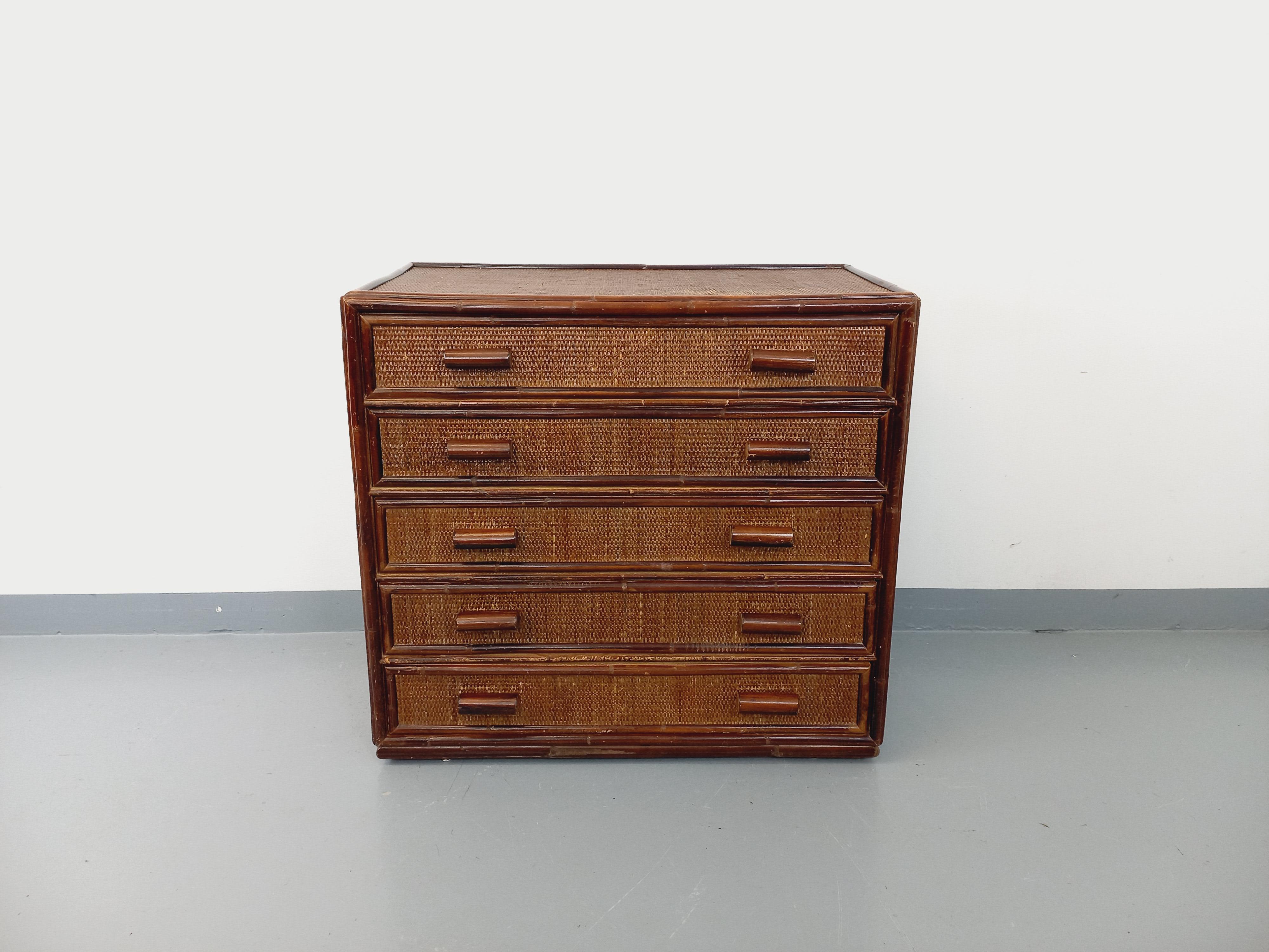 Commode vintage des années 70, en rotin et rotin tressé foncé, 5 tiroirs intérieur bois, bon état général avec patine du temps qui passe.
Ref 240 725
Hauteur : 81 cm
Largeur : 86 cm
Profondeur : 46 cm

