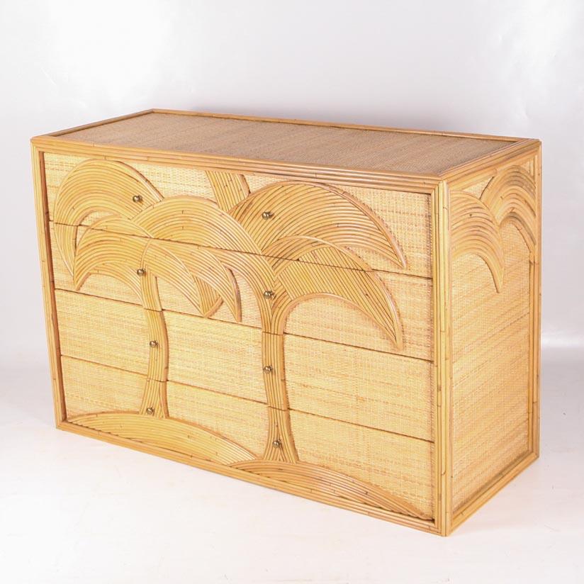 Beautiful chest of drawers with 4 drawers in rattan and raffia with palmtrees patterns on the face and on the sides. With its brass handles, its design is unique and typical of the Italy of the seventies.
High quality work, entirely hand made.