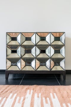 Commode with antique mirrored faceted panels and black interior, model “Ducale”.