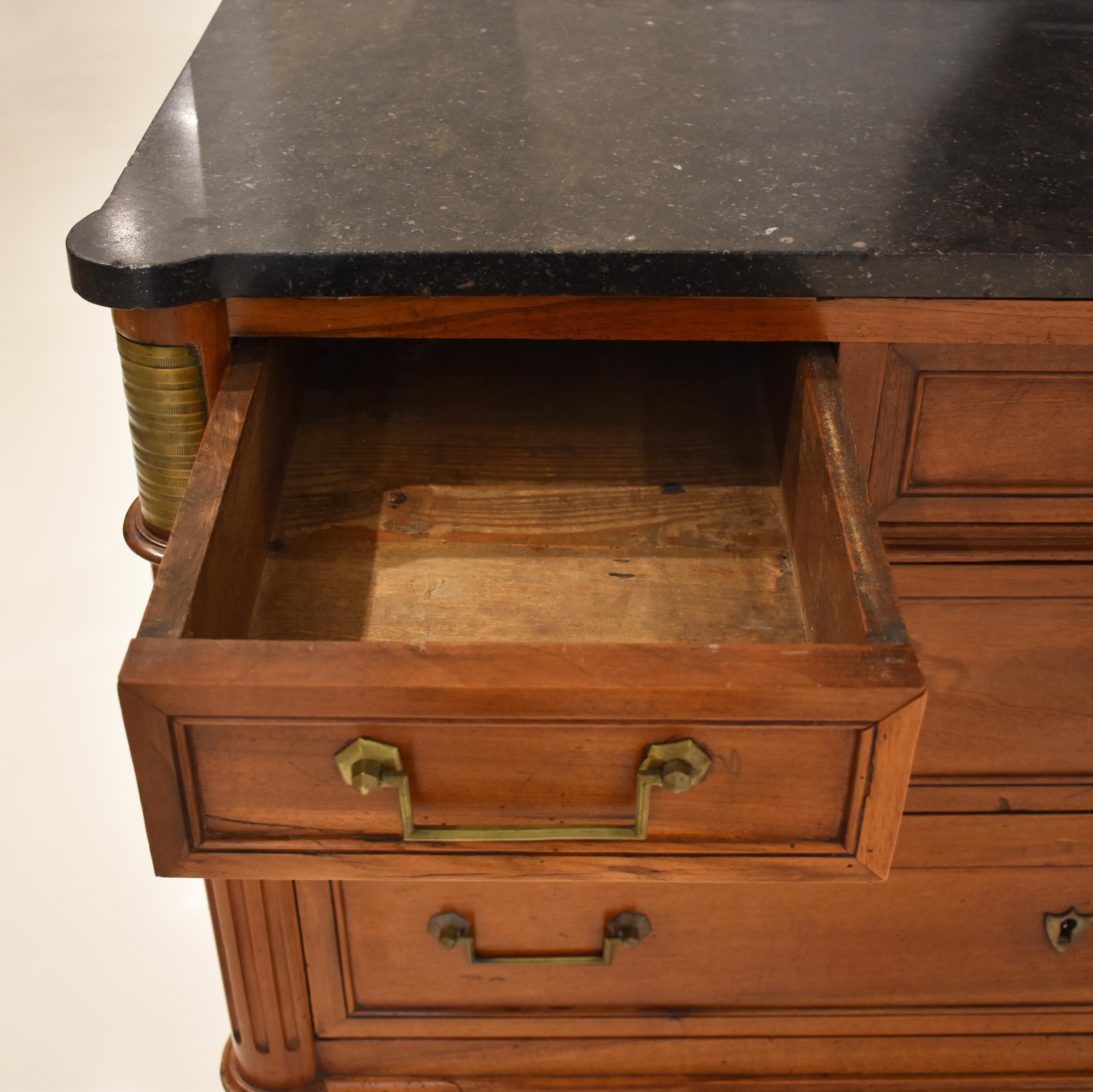 This 19c French Louis XVI style walnut commode with marble top has classic line and tapered legs that allow it to work seamlessly in any decor. Bronze ormolu accent complete the look.
