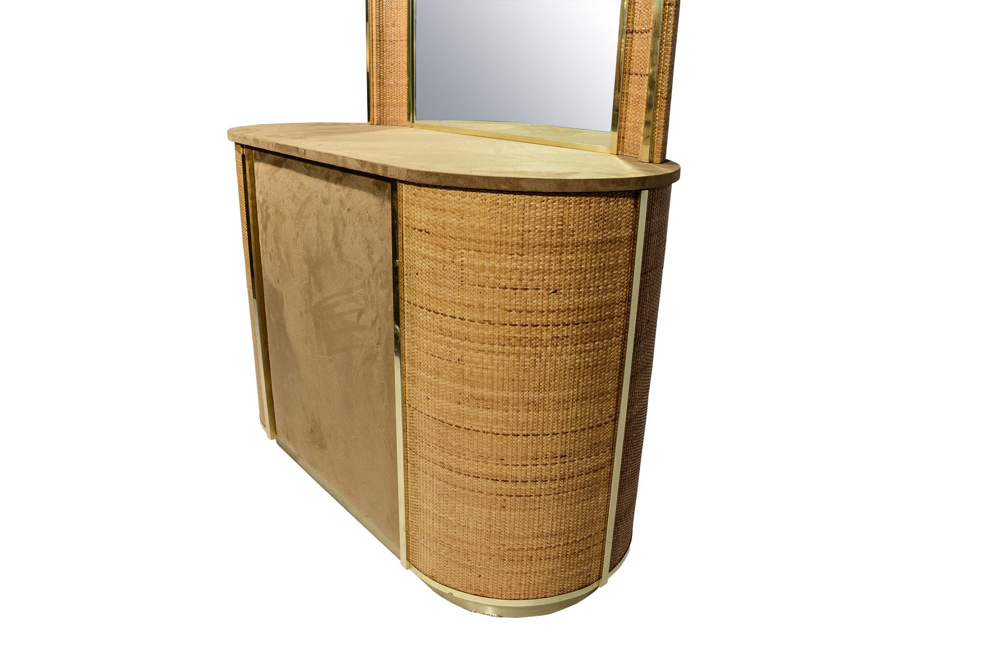 Commode with mirror, 
rattan, original textile and gilt brass,
circa 1970, Italy.
Measures: Cabinet: height 71 cm, width 103 cm, depth 46 cm.
Mirror: height 76 cm, width 85 cm, depth 10 cm.