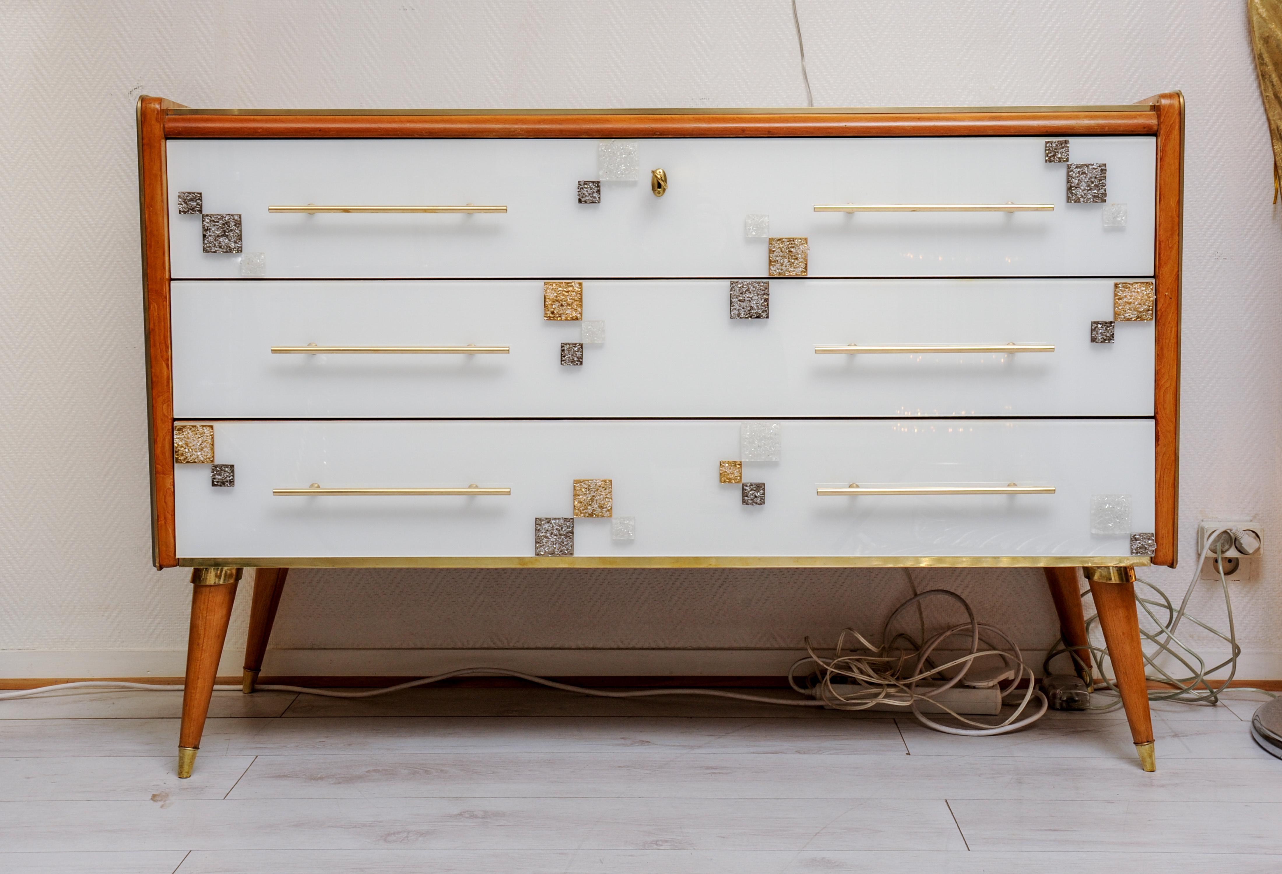 Commode with three drawers in teinted white glass with applications of Murano glass.