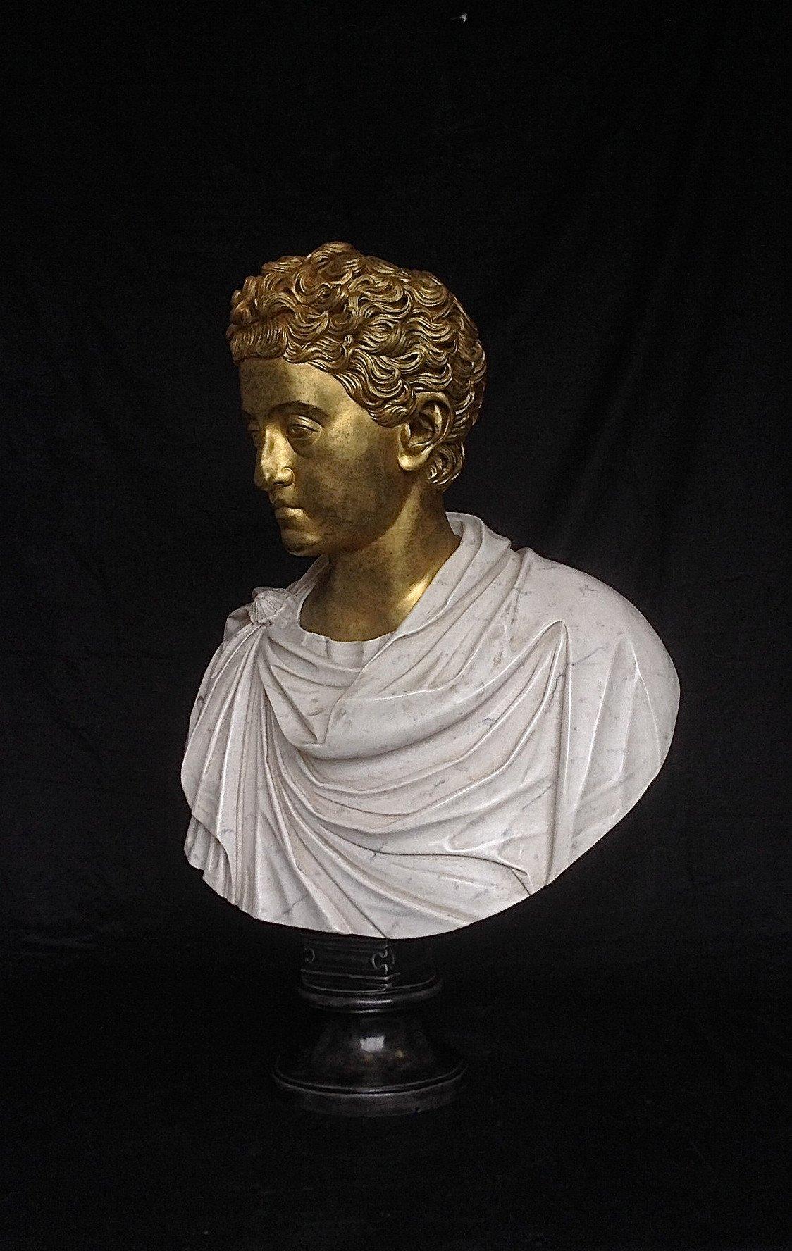 A stunning Commodus Marble Bust With Gilt head, 20th century.
Commodus Roman Emperor, 180-192 AD, after the antique, by the workshop of Bartolomeo Cavaceppi, (1719-1799),
depicted facing to dexter, on a circular marble base.

This bust is