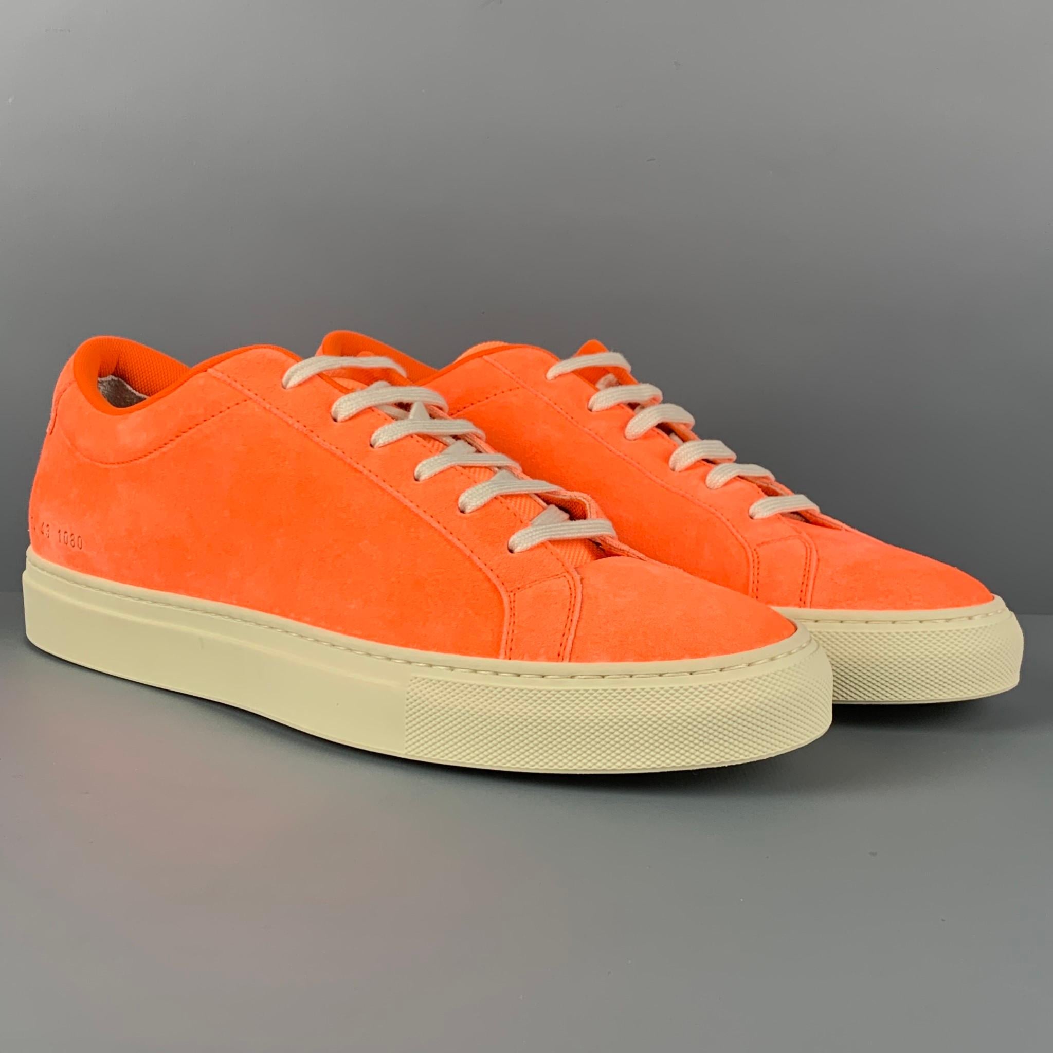 COMMON PROJECTS sneakers comes in a neon orange suede featuring a low top style, rubber sole, and a lace up closure. Made in Italy. 

New With Box. 
Marked: 43

Outsole: 11.75 in. x 4 in. 