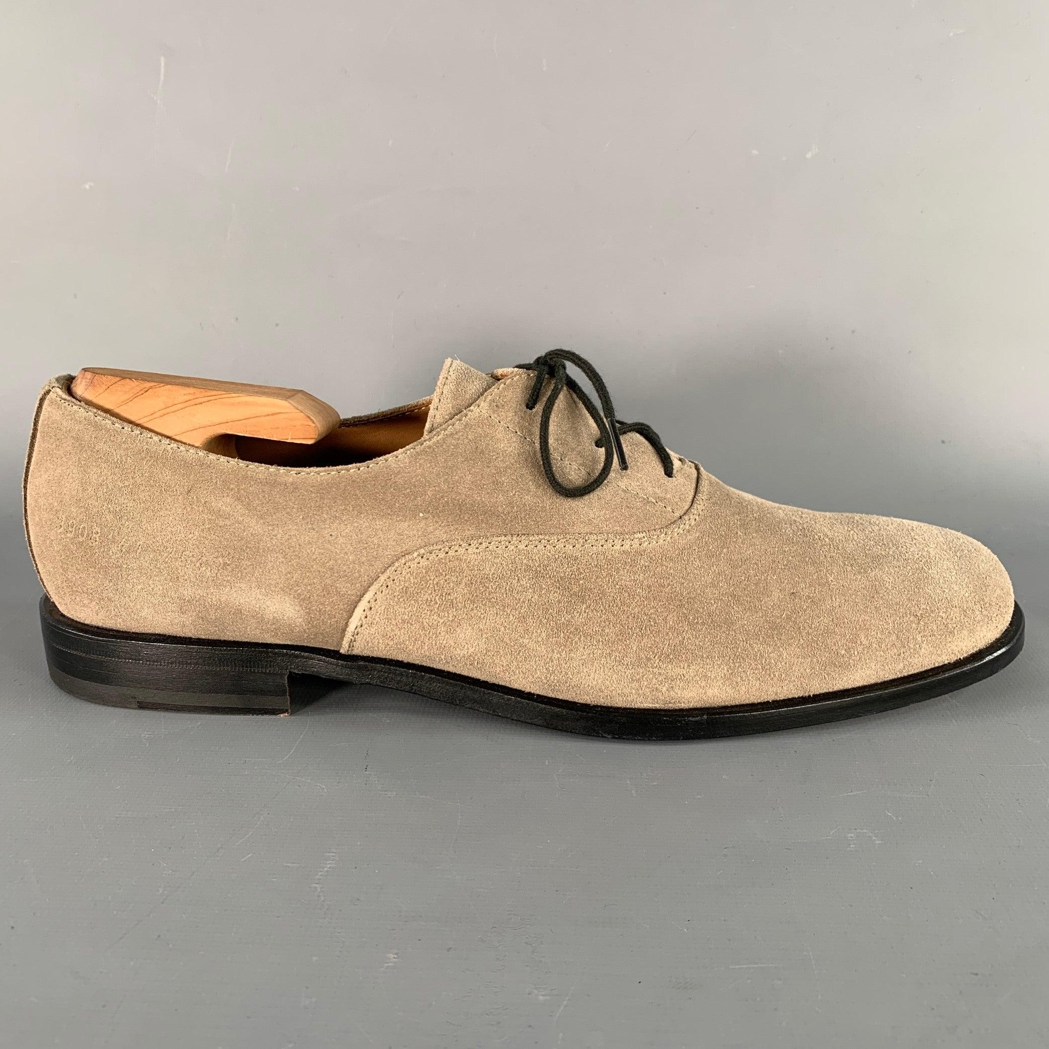 WOMAN by COMMON PROJECTS shoes in a taupe suede featuring an oxford style, leather sole, and lace-up closure. Shoe trees not included. Made in Italy.Very Good Pre-Owned Condition. Minor signs of wear. 

Marked:   3908 41 7543Outsole: 11.25 inches  x