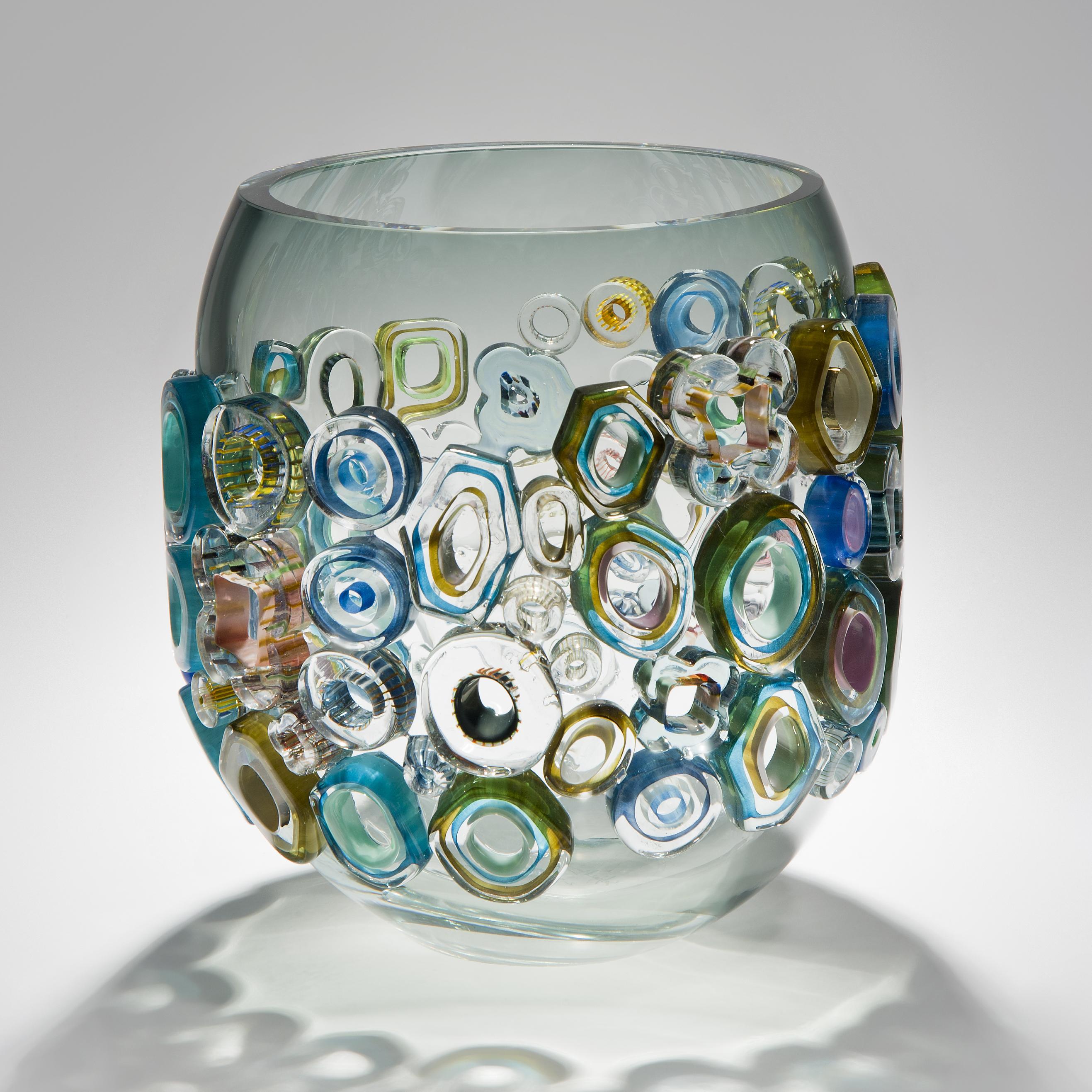 Common ray blue green with green diamonds is a unique hand blown and crafted vase by the German artist, Sabine Lintzen. The initial inner form is free-blown and adorned with various individually shaped murrini, all created in a mix of colored glass