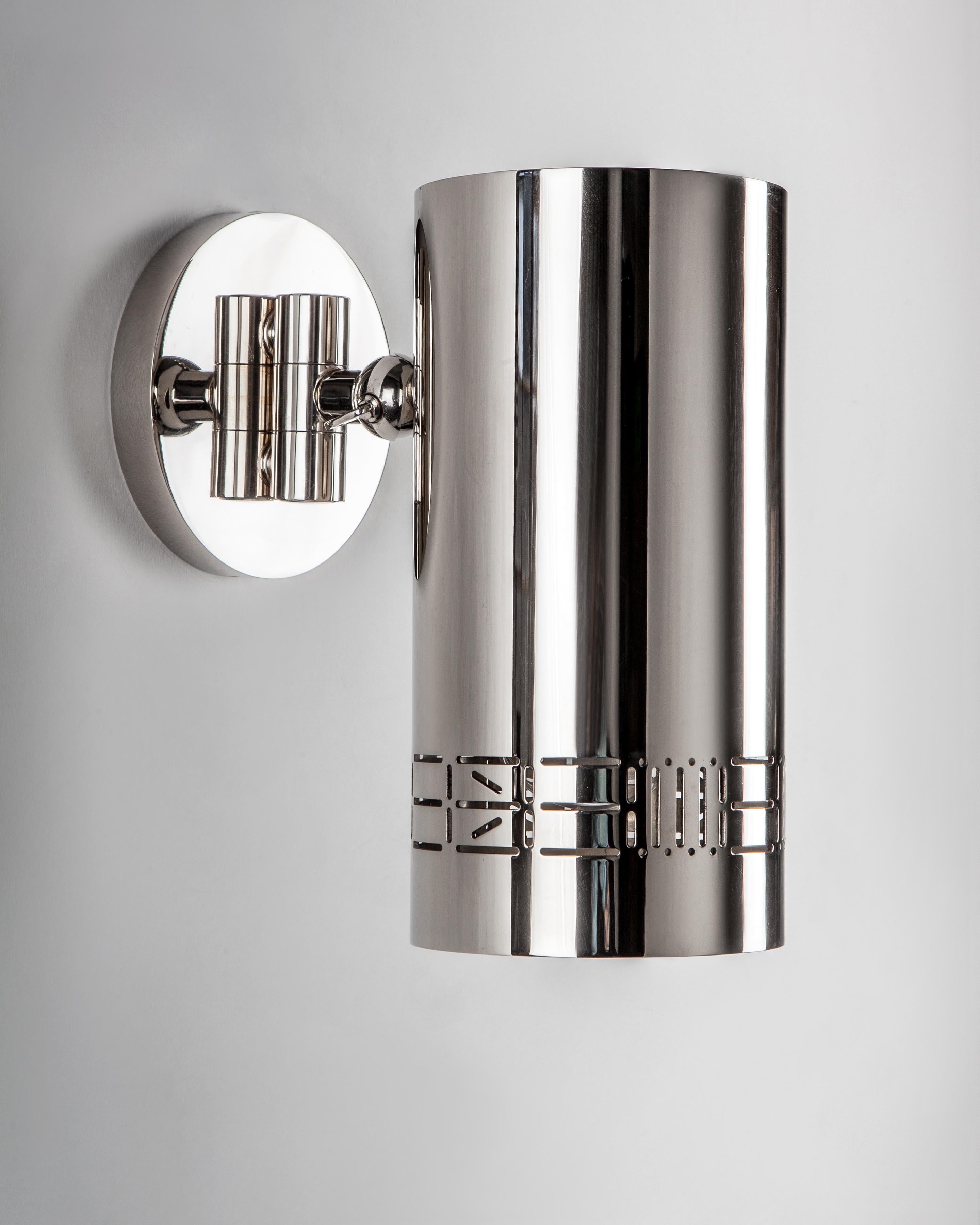 CIS3305
The Can Reading Sconce has a cylindrical pierced shade with commune's signature 