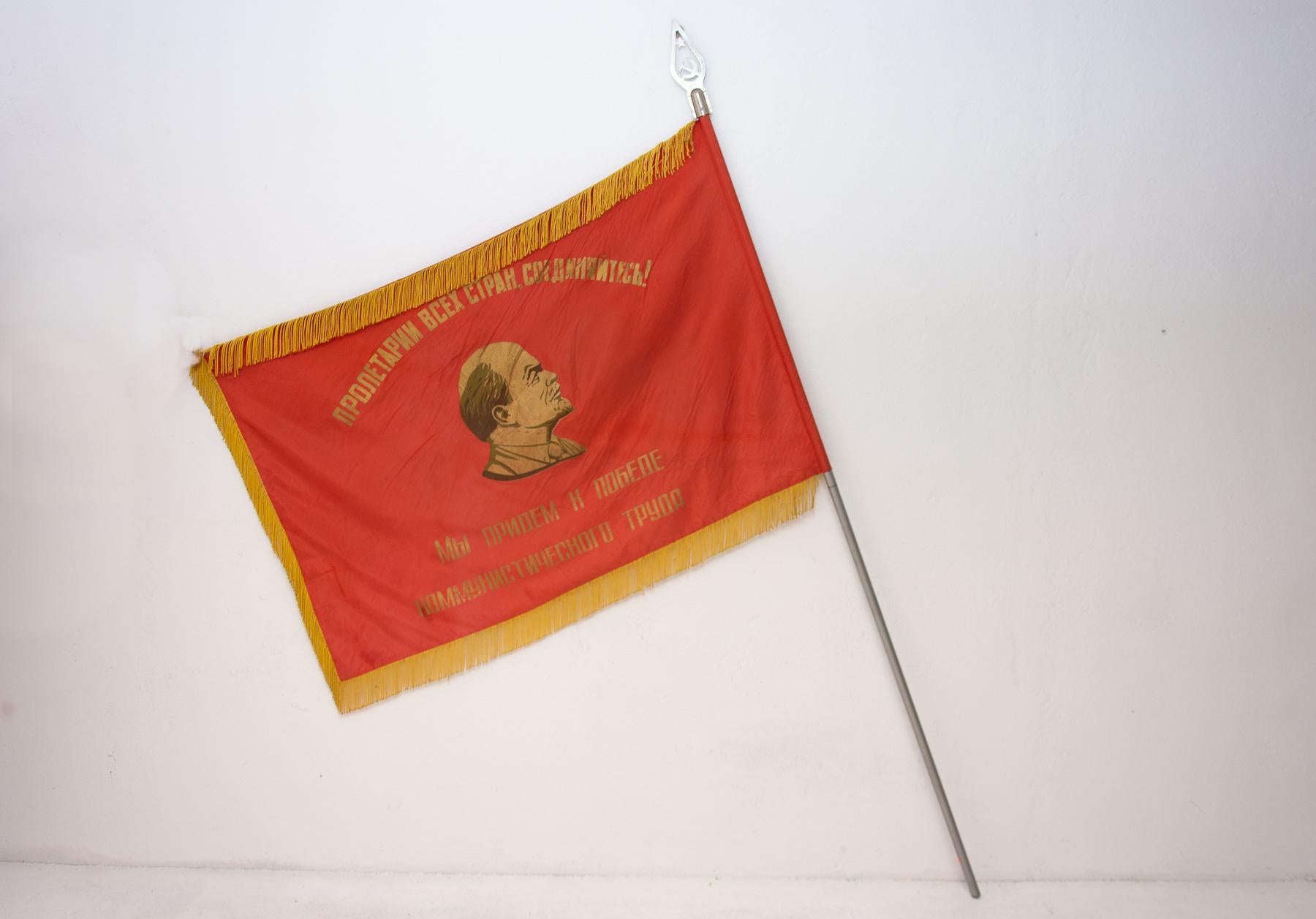 Old original flag from 1950s with a portrait of Vladimir Ilyich Lenin. The slogan  - “Proletarians of all countries unite!” is written on the flag.
The flag is in very good condition, it was torn in one place, but the seam is repaired. It is made of