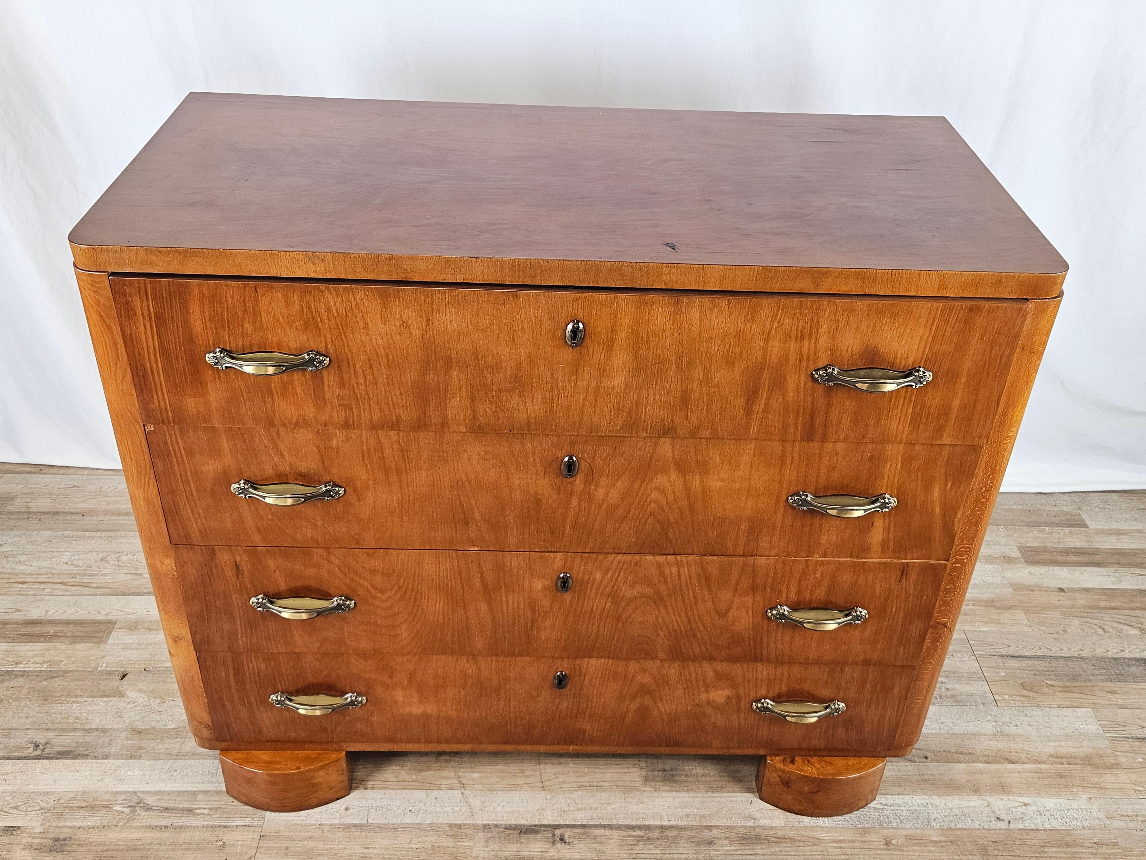 Chamber dresser made circa 1940 entirely of wood with four large, sturdy drawers.

The cabinet lends itself well to all kinds of environments thanks to its small size and soft, gentle wood tone.

Brass handles placed after the furniture was