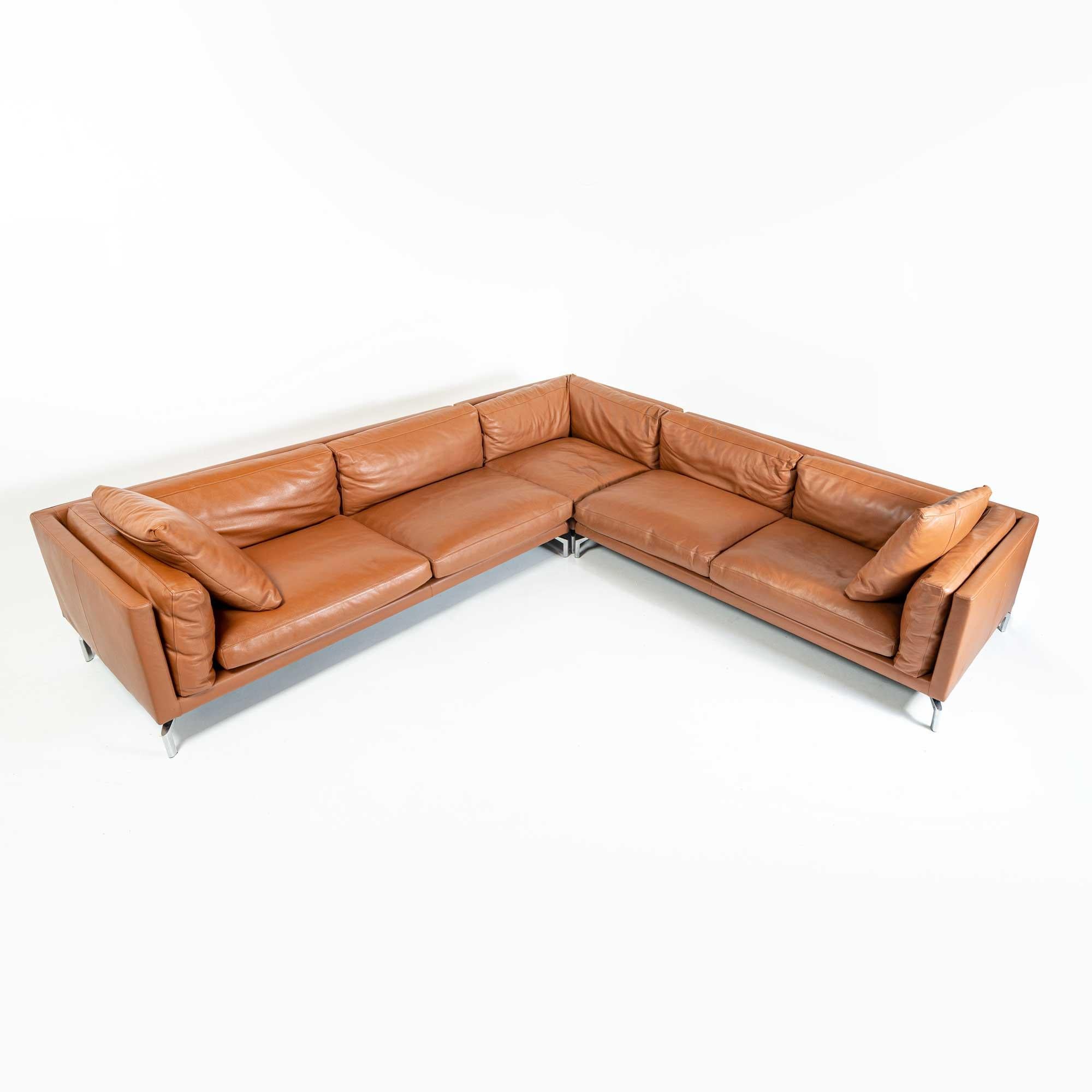 This is a complete Como Corner Sectional Sofa, Designed by Giorgio Soressi, for DWR. The sectional has three section, two open arm sofas, a corner seating and two oversized throw pillow. Natural Down feather for back cushions and foam filled for