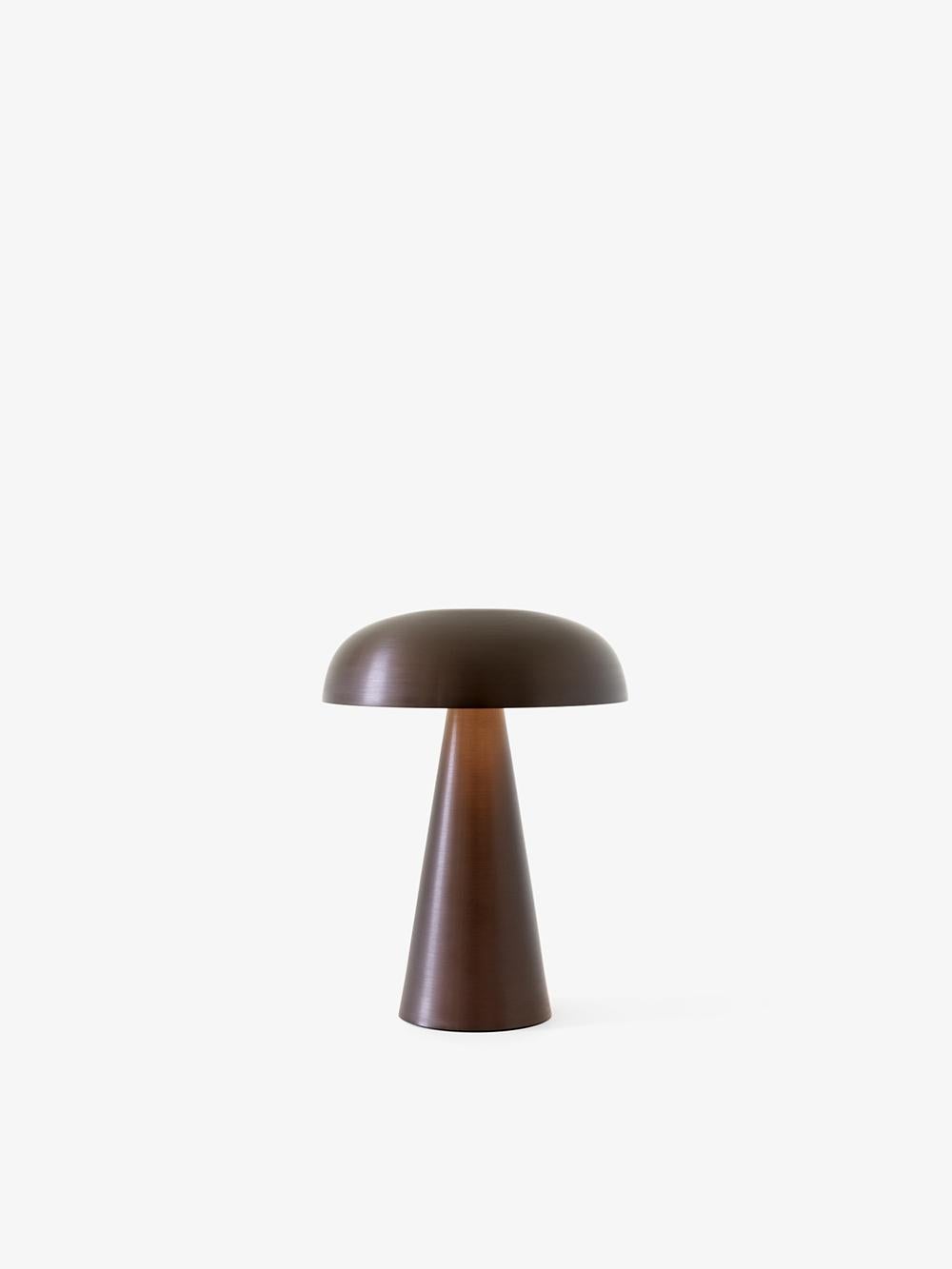 Match lighting to mood with Como SC53, a portable table lamp from Space Copenhagen. 
Crafted from anodized aluminium, Como’s sturdy base tapers up towards a softy curved, mushroom-shaped shade. 
This battery-powered lamp can operate for eleven hours