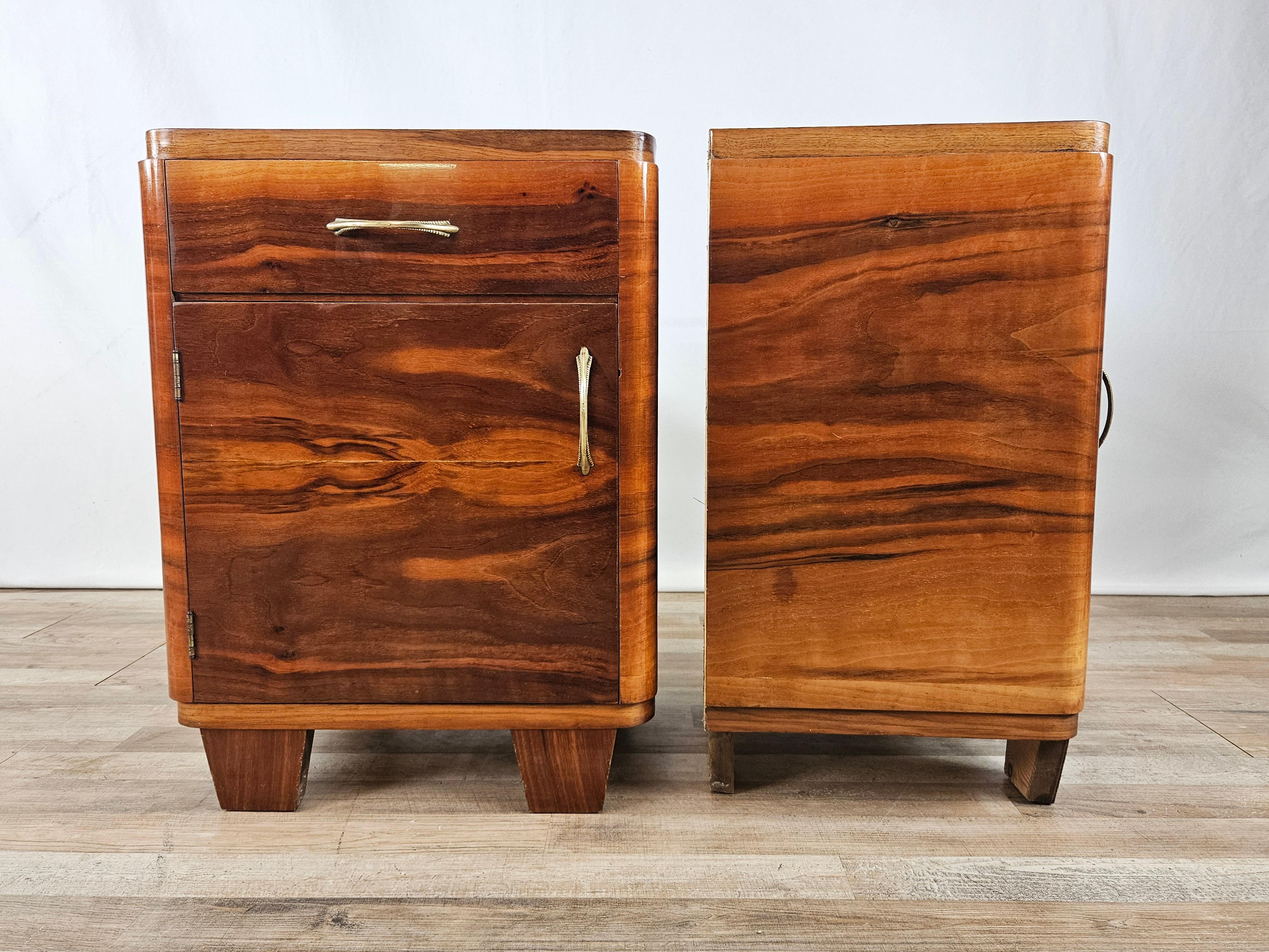Italian-made 1950s bedside tables in polished walnut, fitted with drawer and door with interior compartment. 
Brass handles original to the period.

They show normal signs of wear due to age and use.