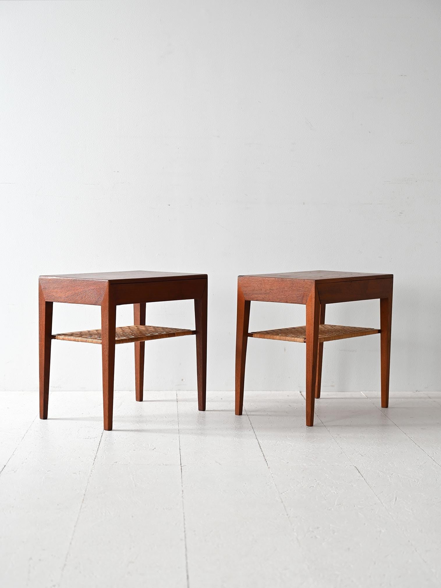 Pair of model 35 bedside tables produced by the Danish company Haslev Møblerfabrik in the 1960s. The stucture is made of teak and features a drawer as well as a rattan magazine rack top.

Featuring a sleek, minimalist design typical of Scandinavian