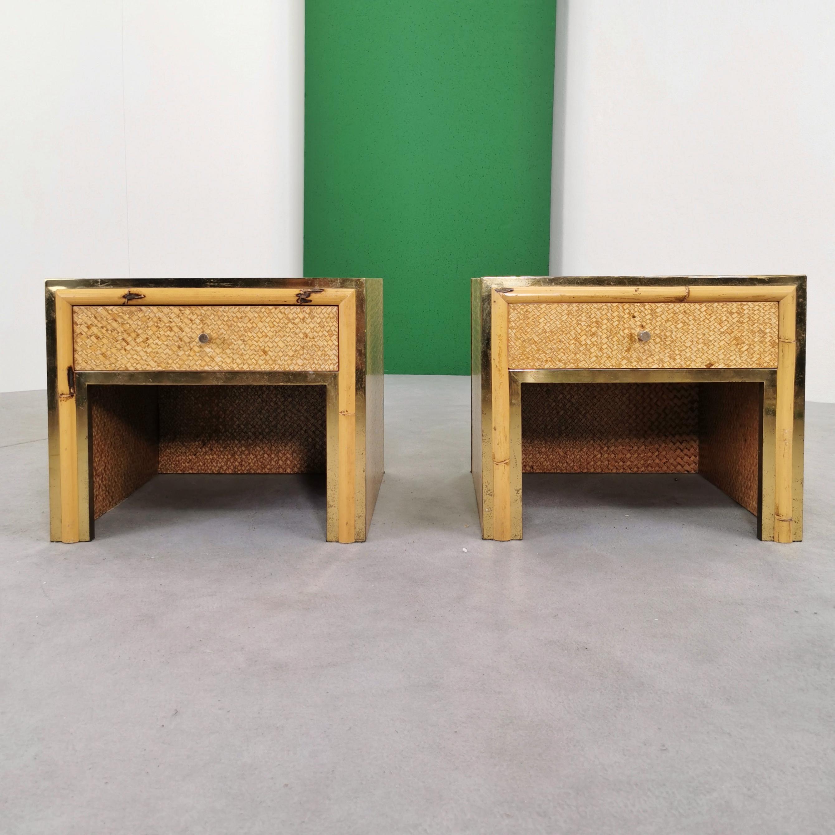 Rare pair of vintage 1970s production nightstands made of clear enameled rattan and brass and bamboo frame. The nightstands present with an image consistent with their age but without any particular signs or defects. directly usable.