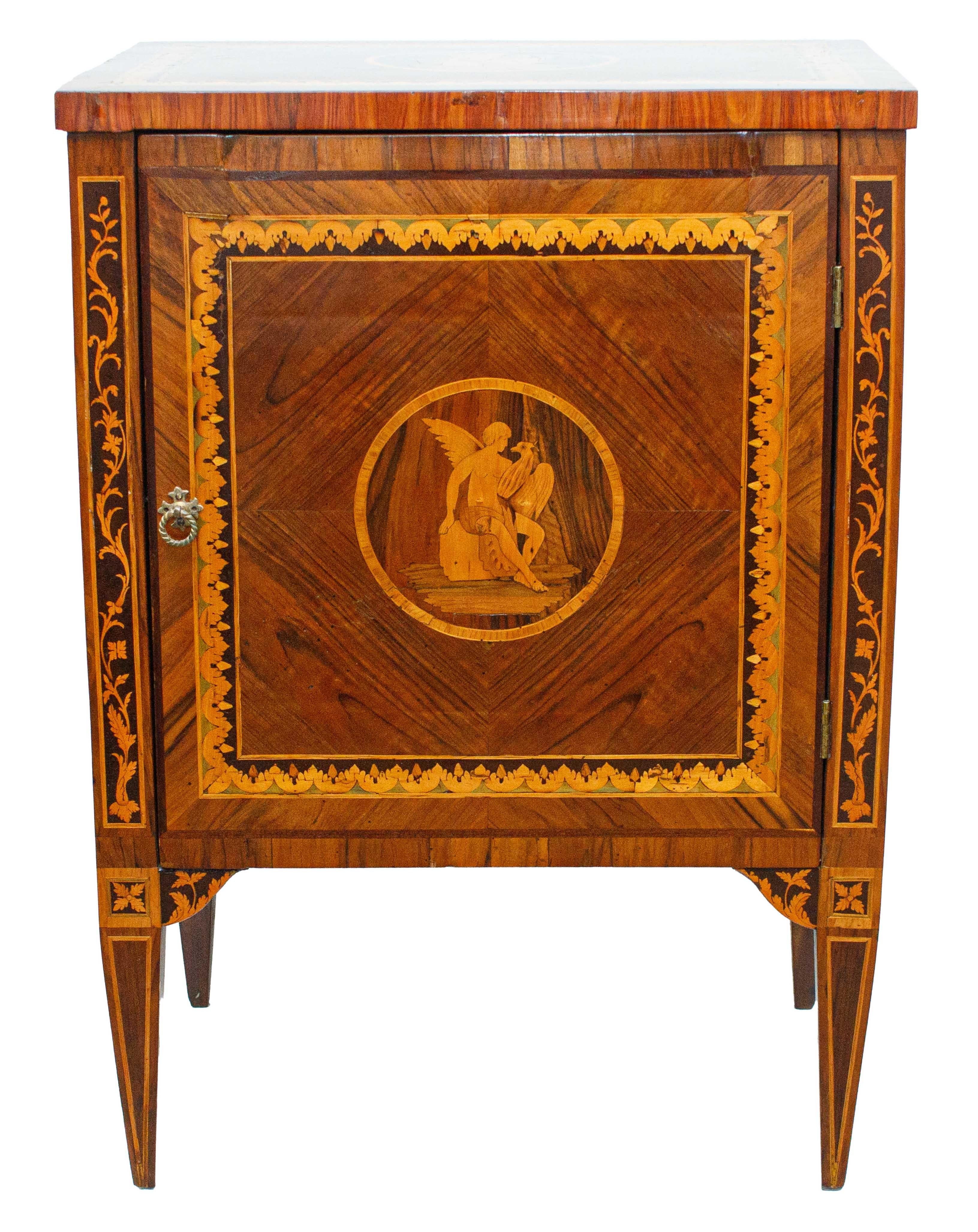 18th century, Louis XVI

Bedside table with Jupiter and eagle

Inlaid wood, 79 x 56 x 40 cm

The piece of furniture under consideration constitutes a splendid example of a Louis XVI-style one-door bedside table made of finely decorated inlaid wood,