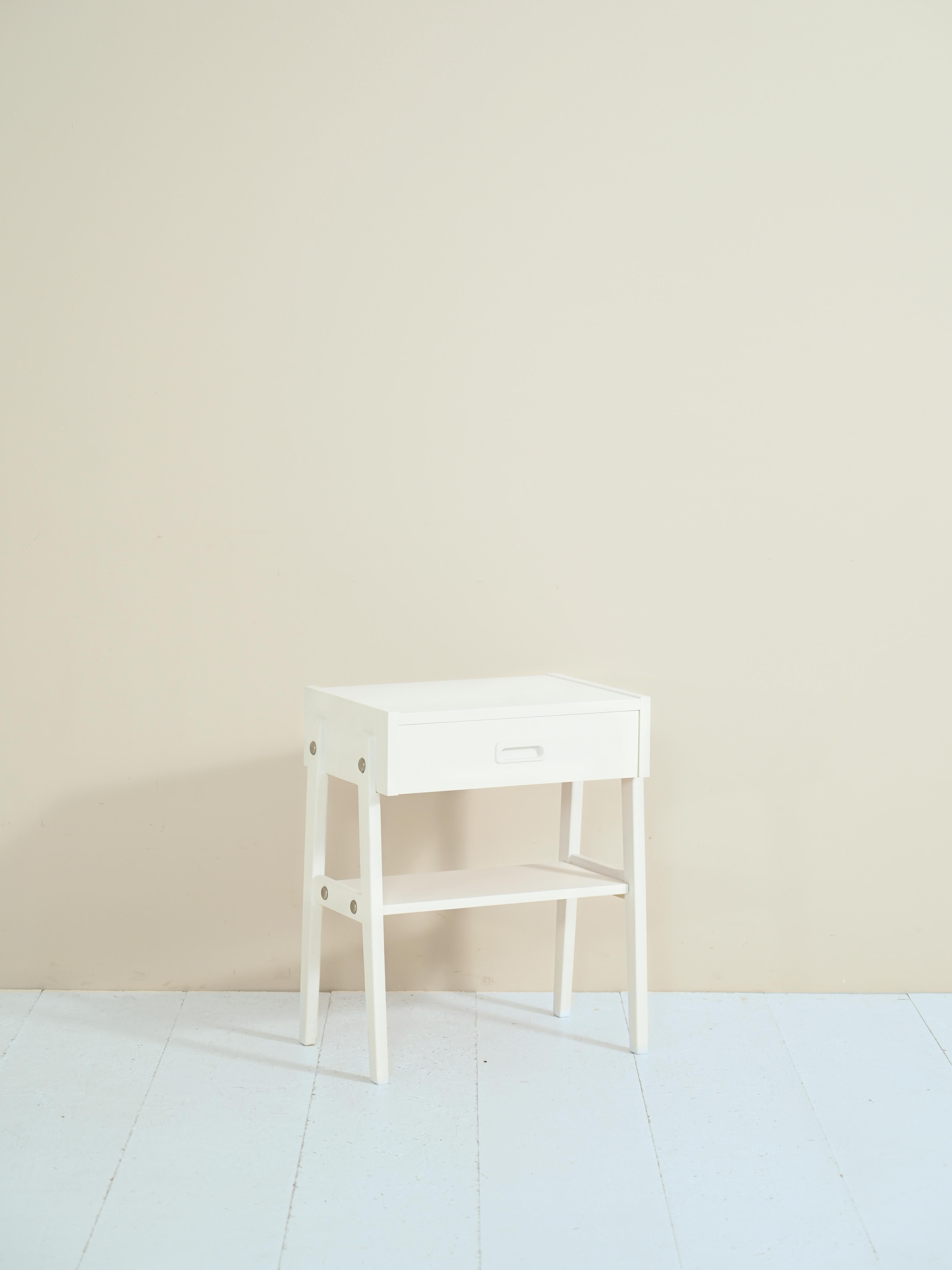 Teak nightstand with drawer.

An original mid-century Nordic design piece of furniture. The wooden structure is painted white. There is also a shelf, convenient for use as a magazine rack.

A piece of furniture that can be used both in its classic