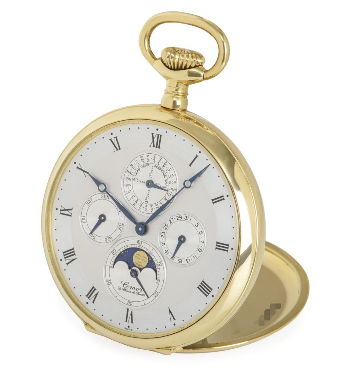 Comor 18kt Yellow Gold Open Face Keyless Lever Perpetual Calendar Moonphase Pocket Watch C1970's

Dial: A Beautiful two tone silvered satin finished chapter ring with Roman numerals. The four satin finished subsidiary dials for day, leap- year cycle