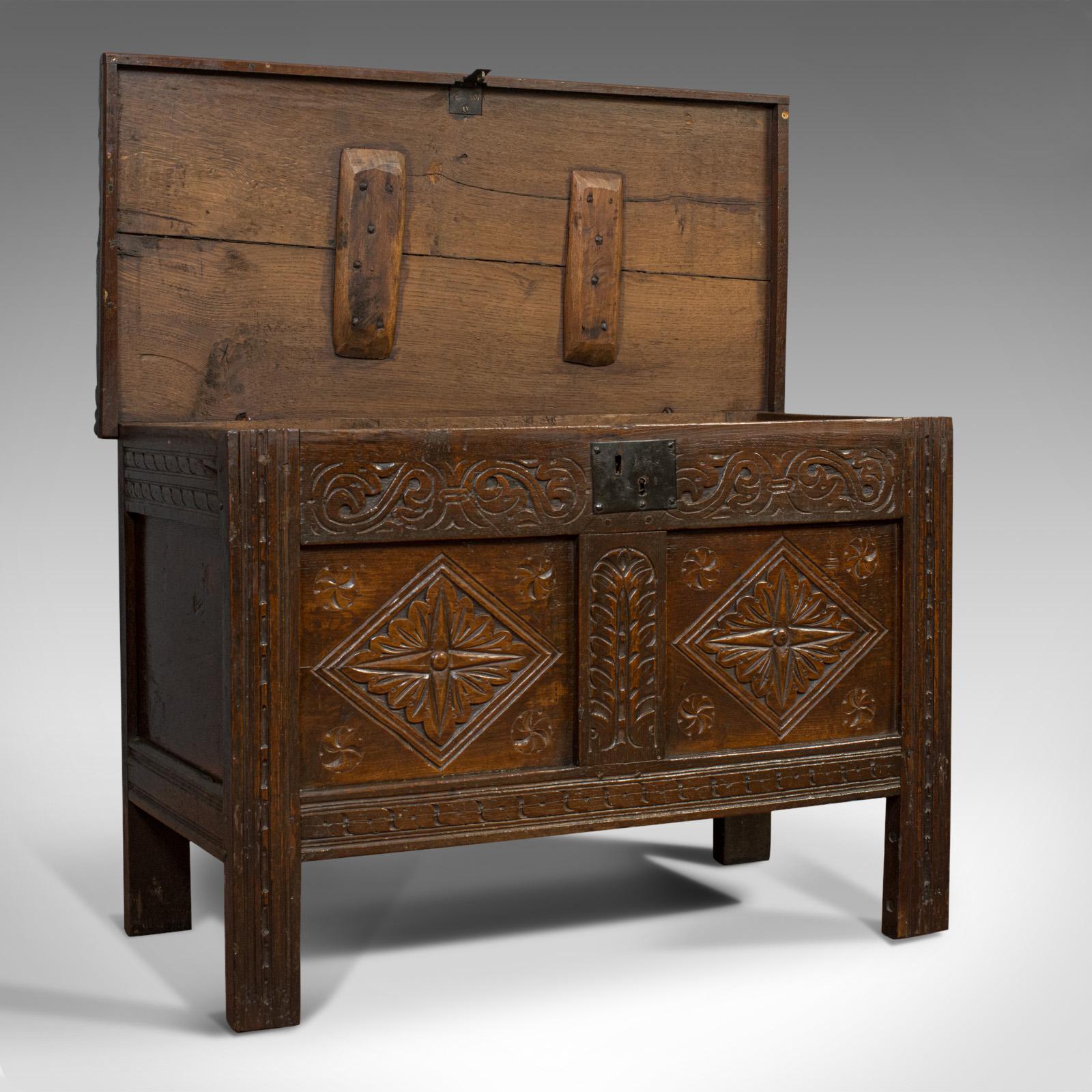 This is a compact antique coffer. An English, oak carved chest or trunk, dating to the early Georgian period, circa 1720.

Superb coffer with fine detail
Displays a desirable aged patina
Highly carved, two panel chest
Select oak with fine grain