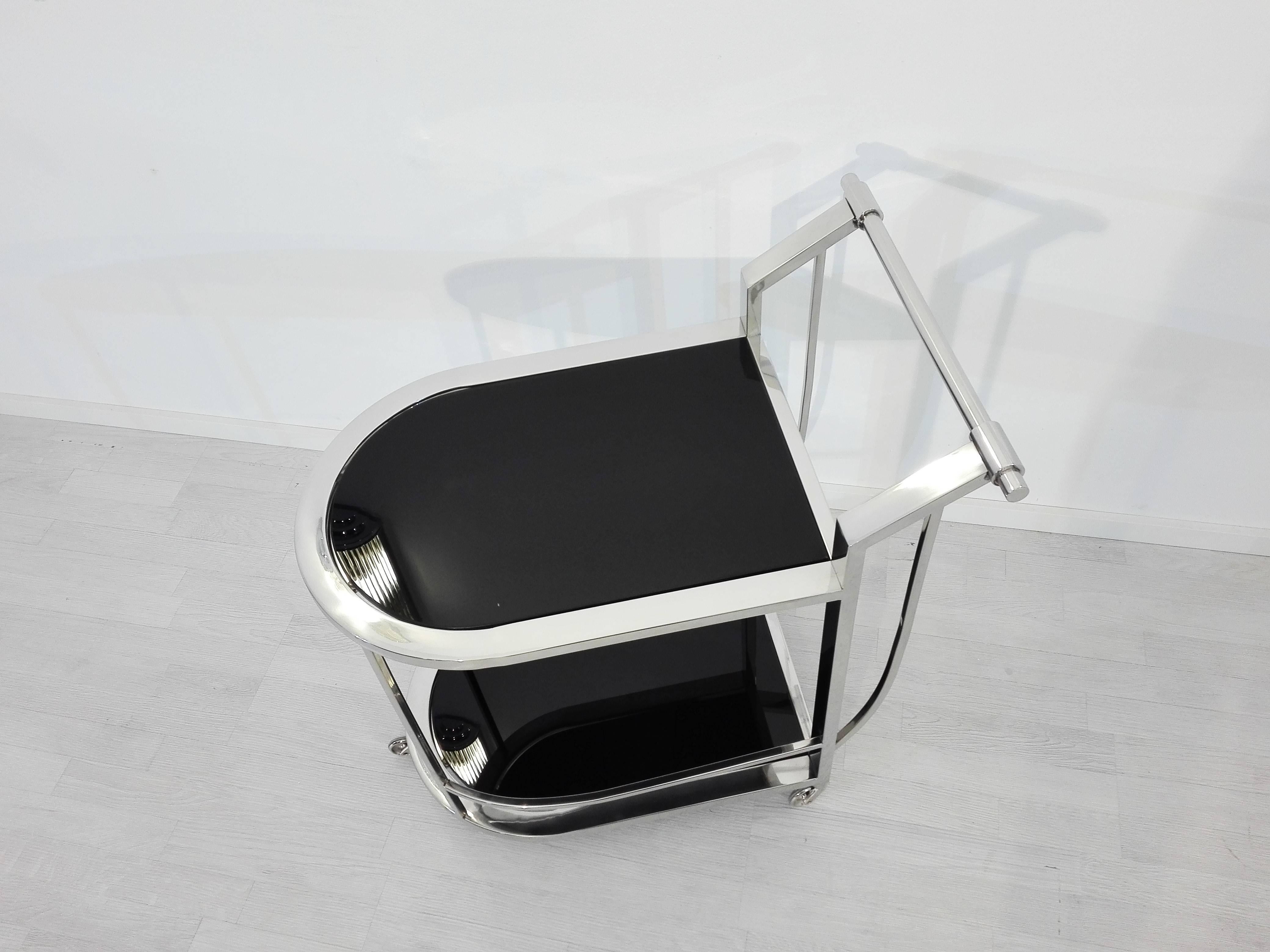 Luxurious serving cart or bar cart with a unique Bauhaus design. Offers two serving levels, a rounded front and a handle. Unique single piece.

 High gloss, completely polychromed frame
 Serving plate made of high quality, black lacobel glass.
 