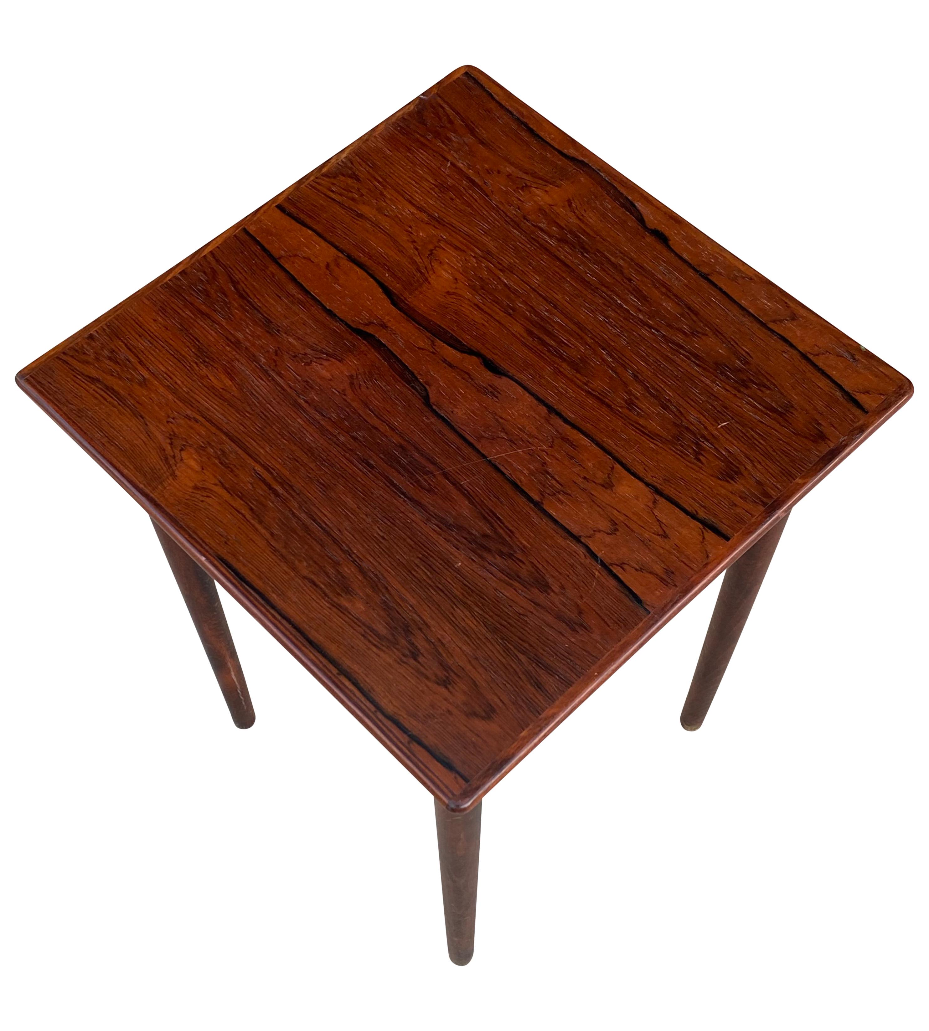 Gorgeous and compact side table made in Norway circa 1960s. Executed in gorgeous Brazilian rosewood with brilliant color and elegant grain pattern. A perfect table for next to a lounge chair or sofa. Minimal age related wear, even color, and no